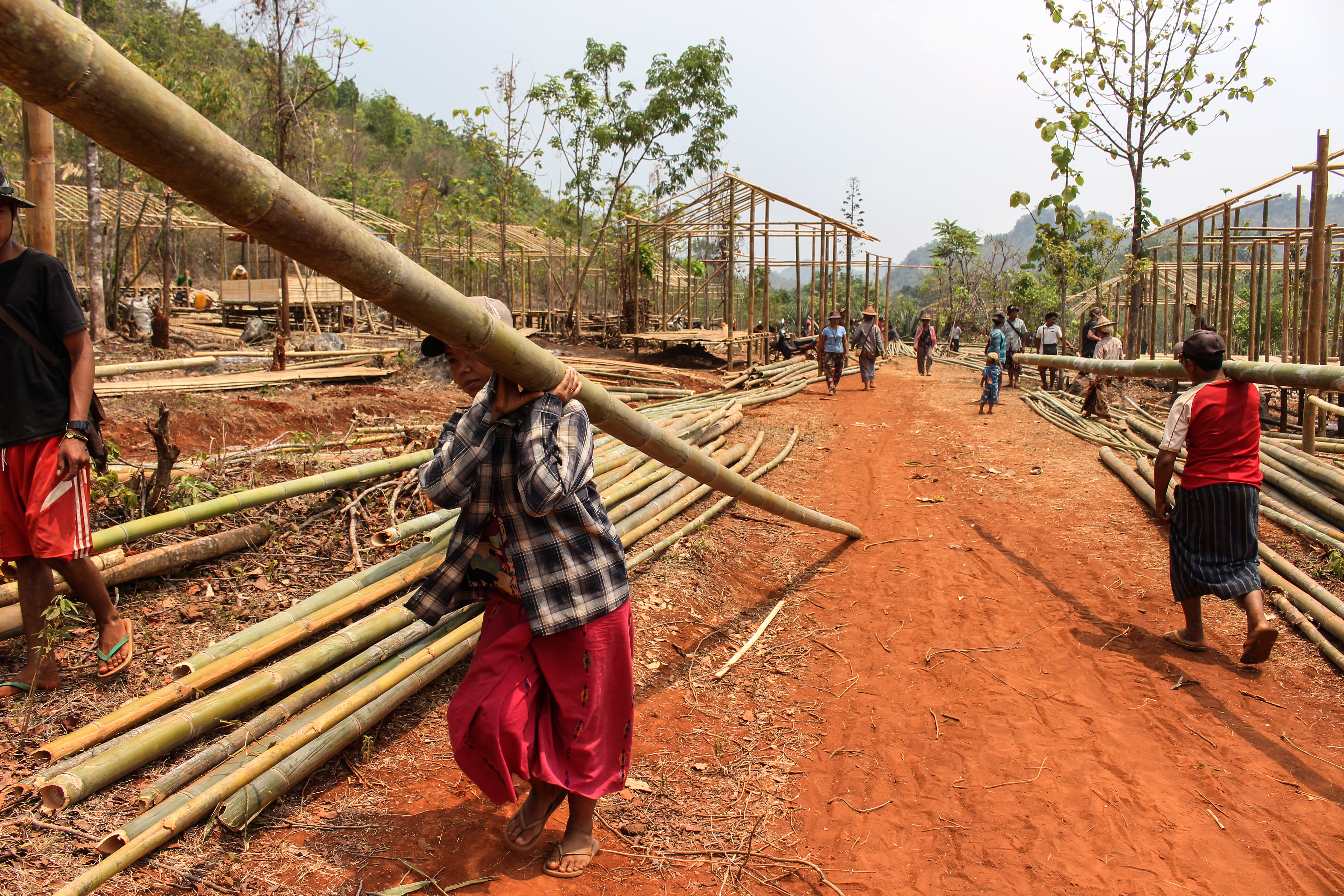 Displaced villagers rebuild their homes for a third time in the Demoso area as they move further from the conflict in Kayah state