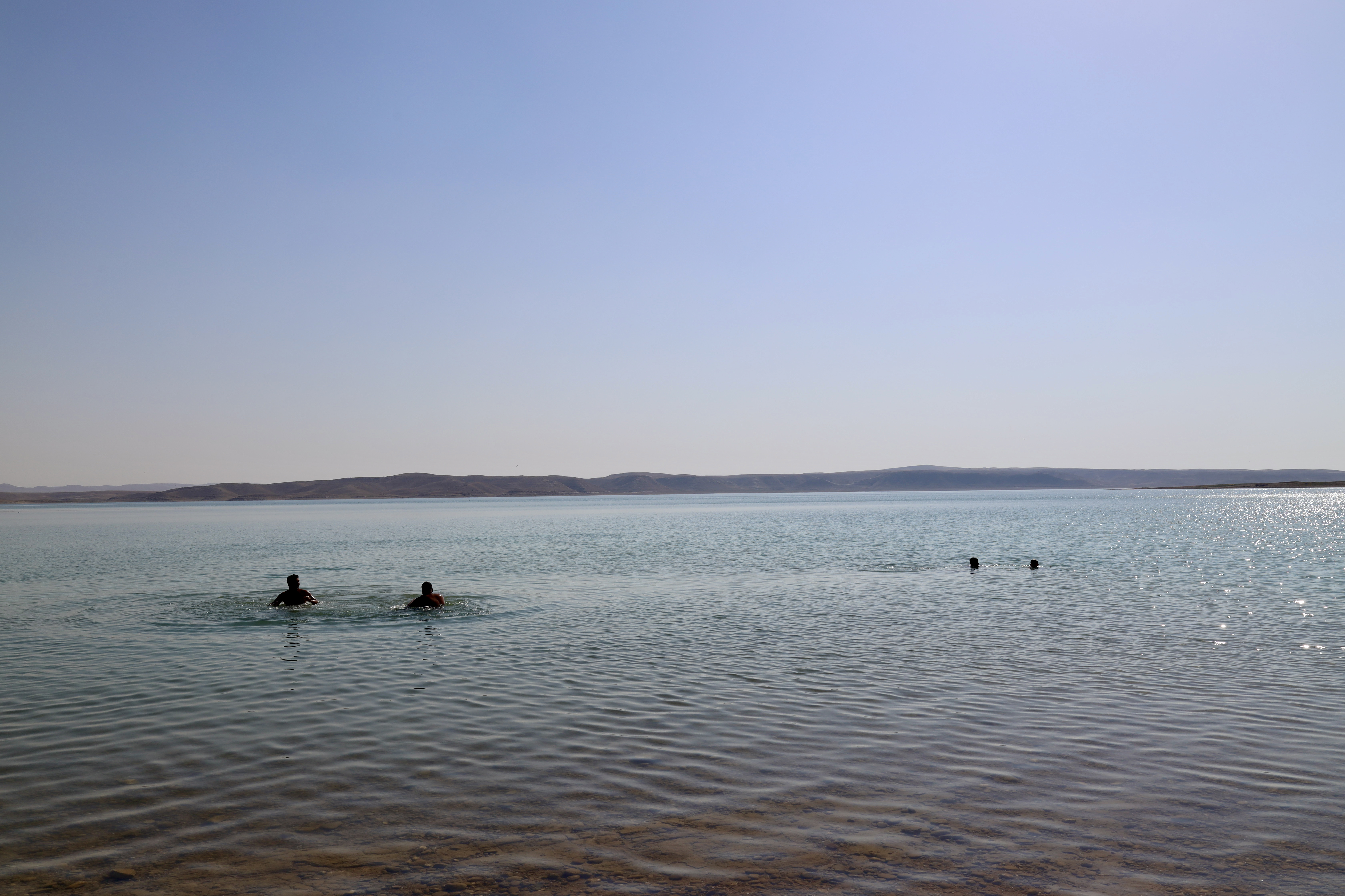 Men swimming in the Khanke (the Tigris River feeding into the Mosul damn), Iraq