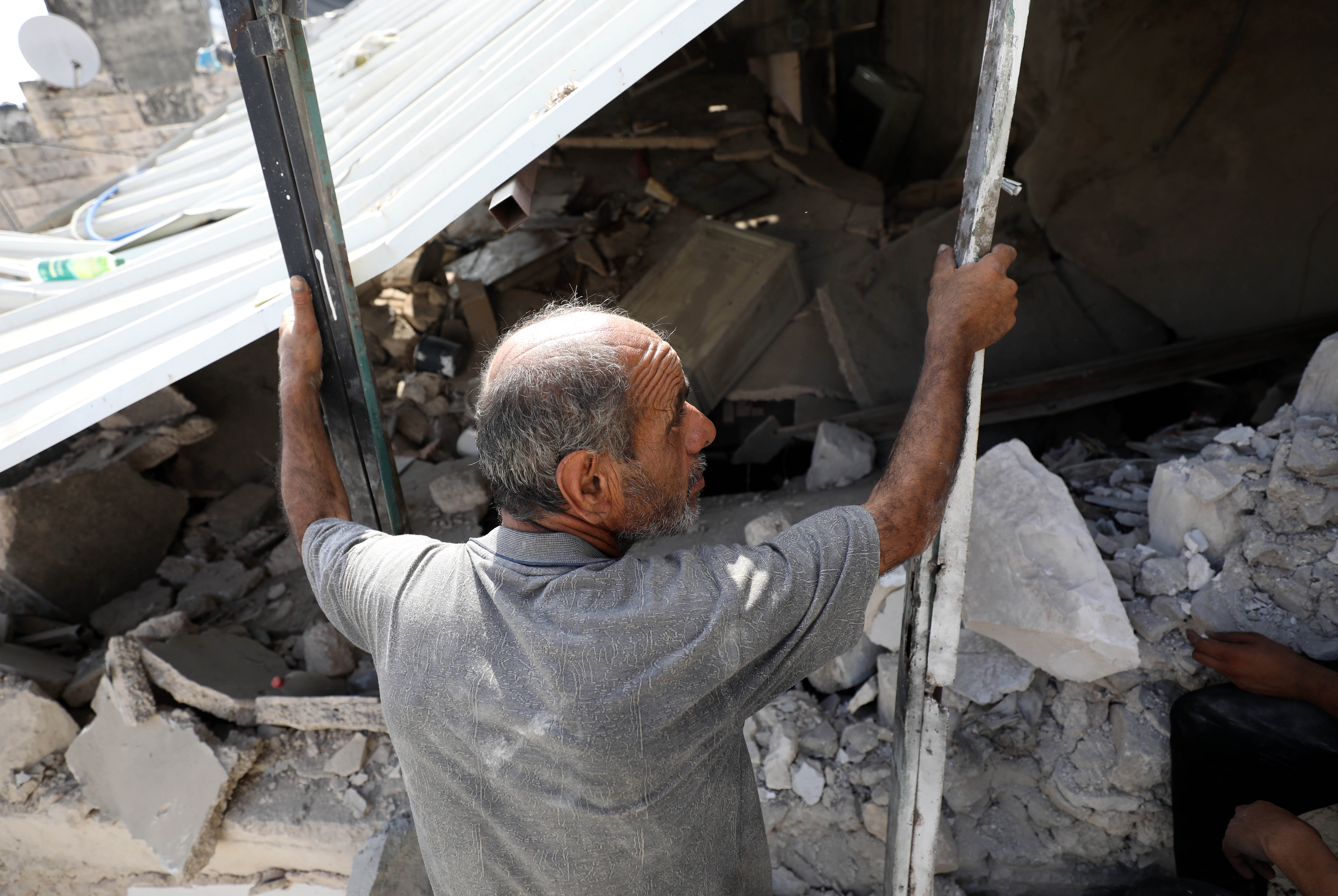 Akram al-Kastoni looks at the wreckage of his family home in Jenin after an Israeli raid killed his son Mustafa and blew up the house on August 17, 2023