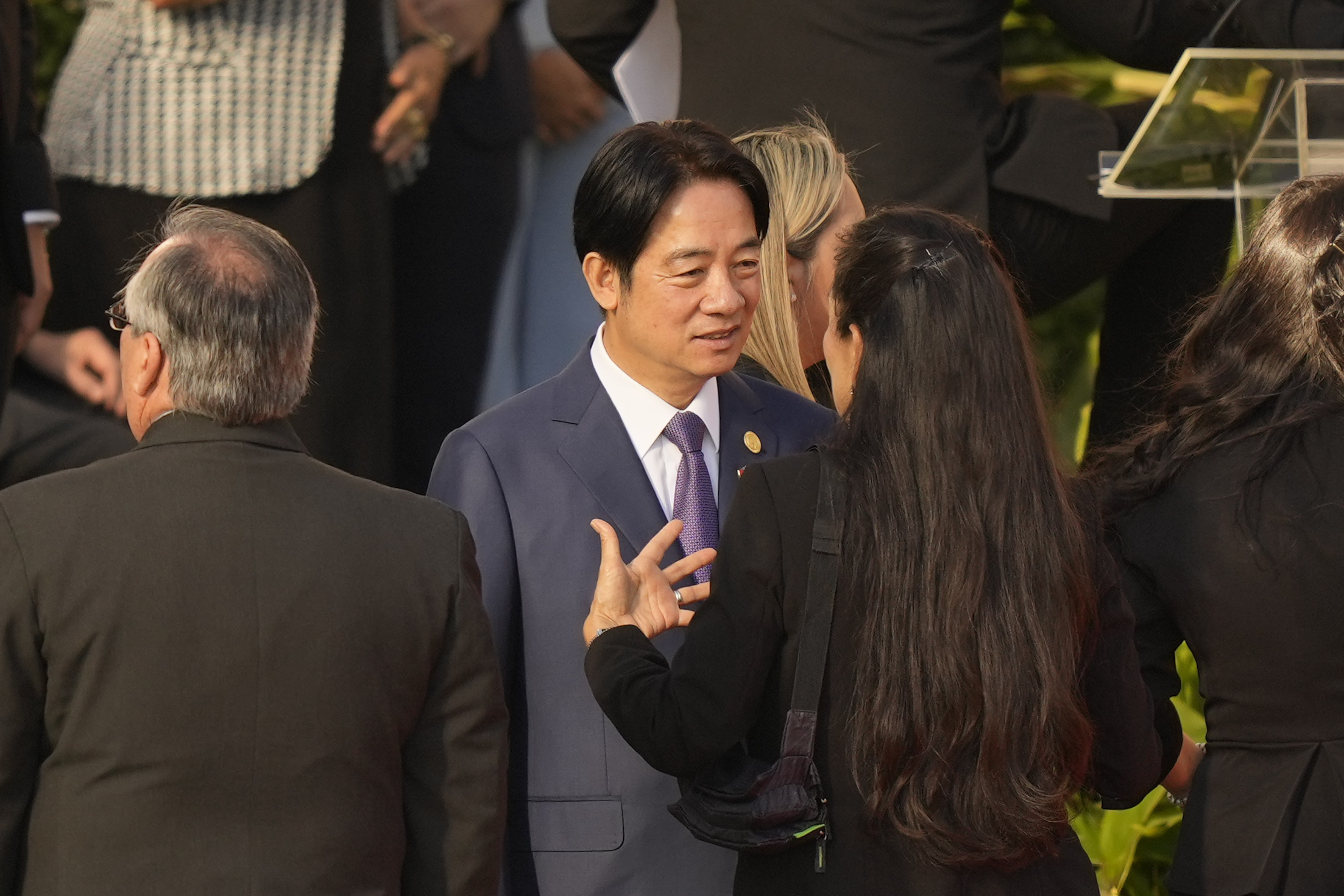 William Lai speaks to another guest, seen from behind, at the swearing-in ceremony.