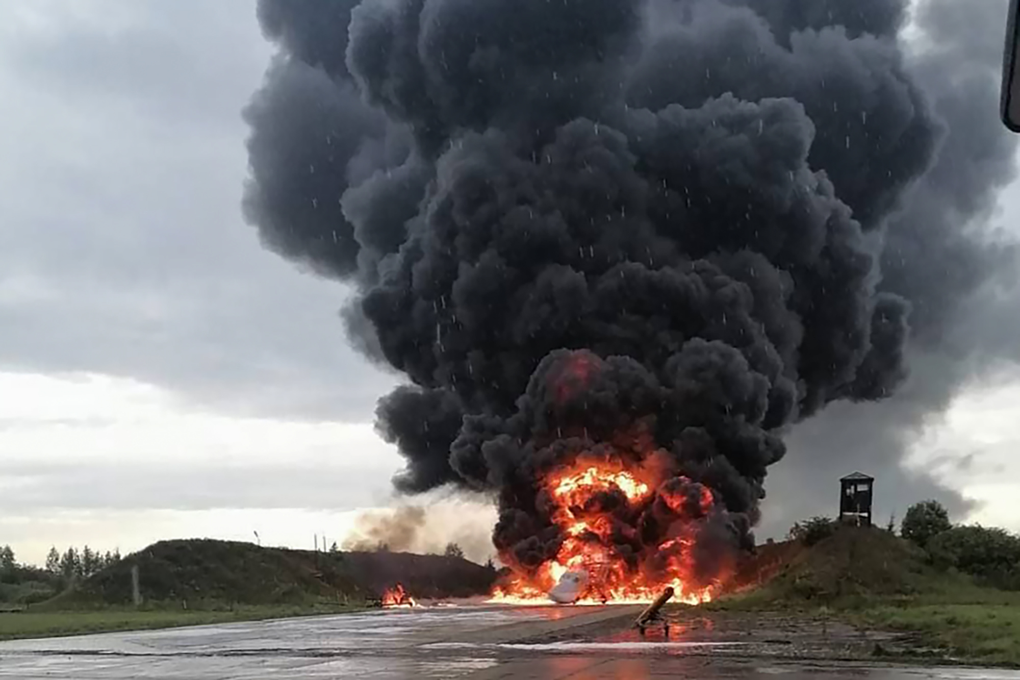 Flames and billowing black smoke rise from a runway on the Soltsy air base after a drone attack