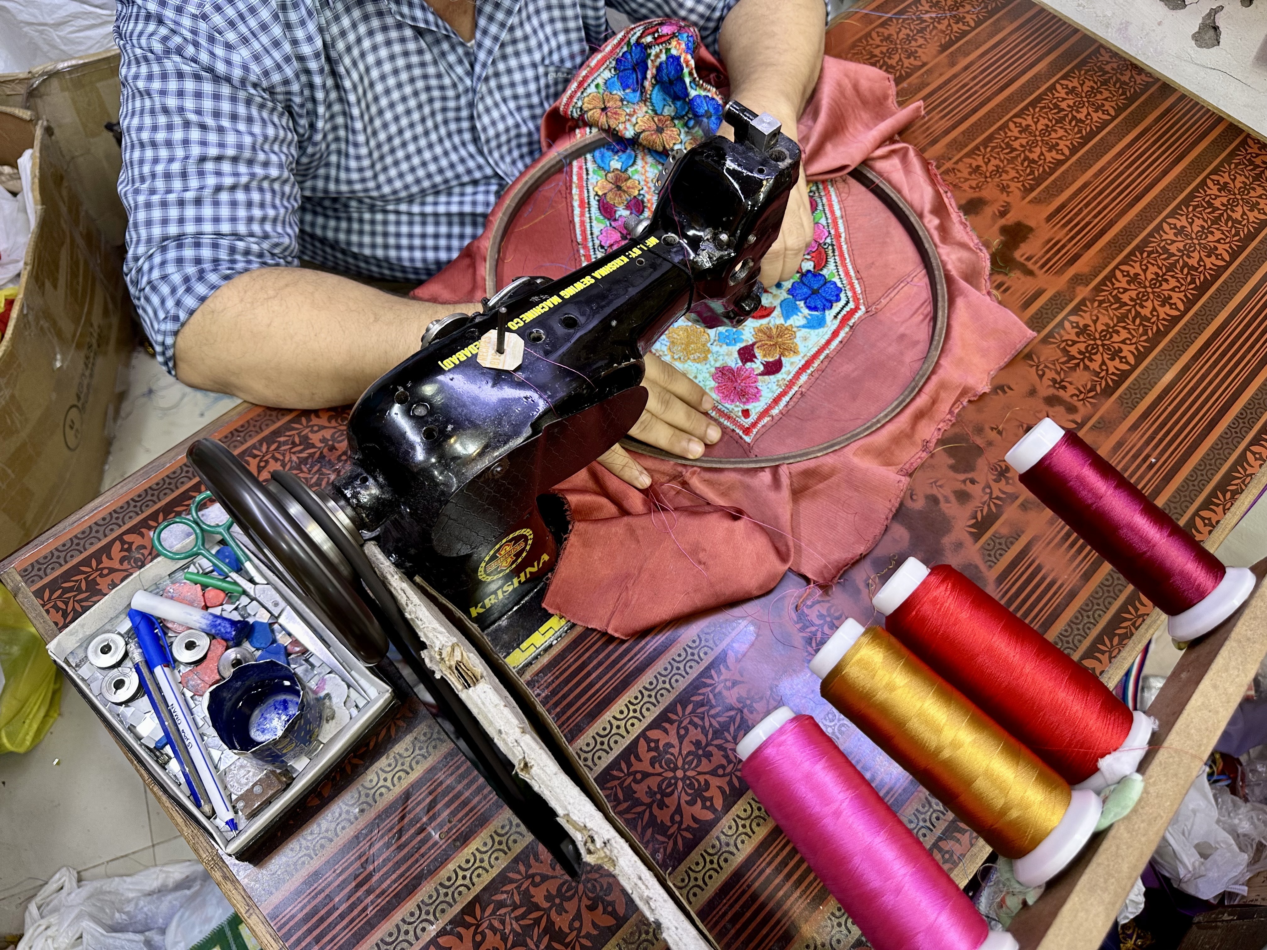 Mohamed sews Baluchi designs with his sewing machine