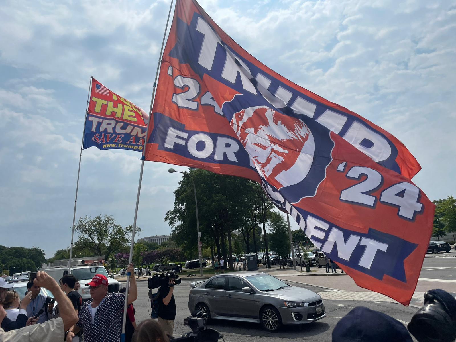 A Trump supporter holds a 2024 flag in Washington, DC
