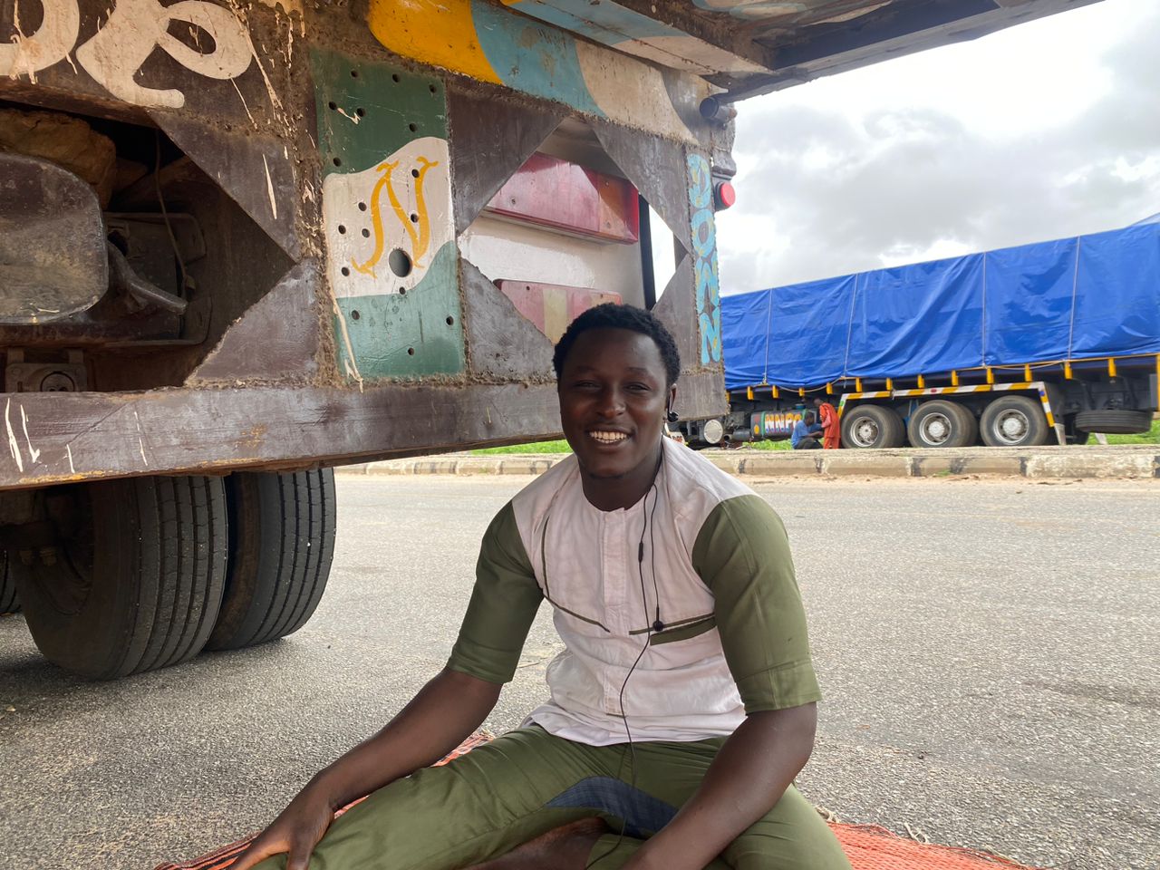 Badamasi Mohammed, a freight truck driver sits beside his truck at the Jibiya border between Nigeria and Niger on August 7, 2023 due to closure of borders between both countries after July 26 coup
