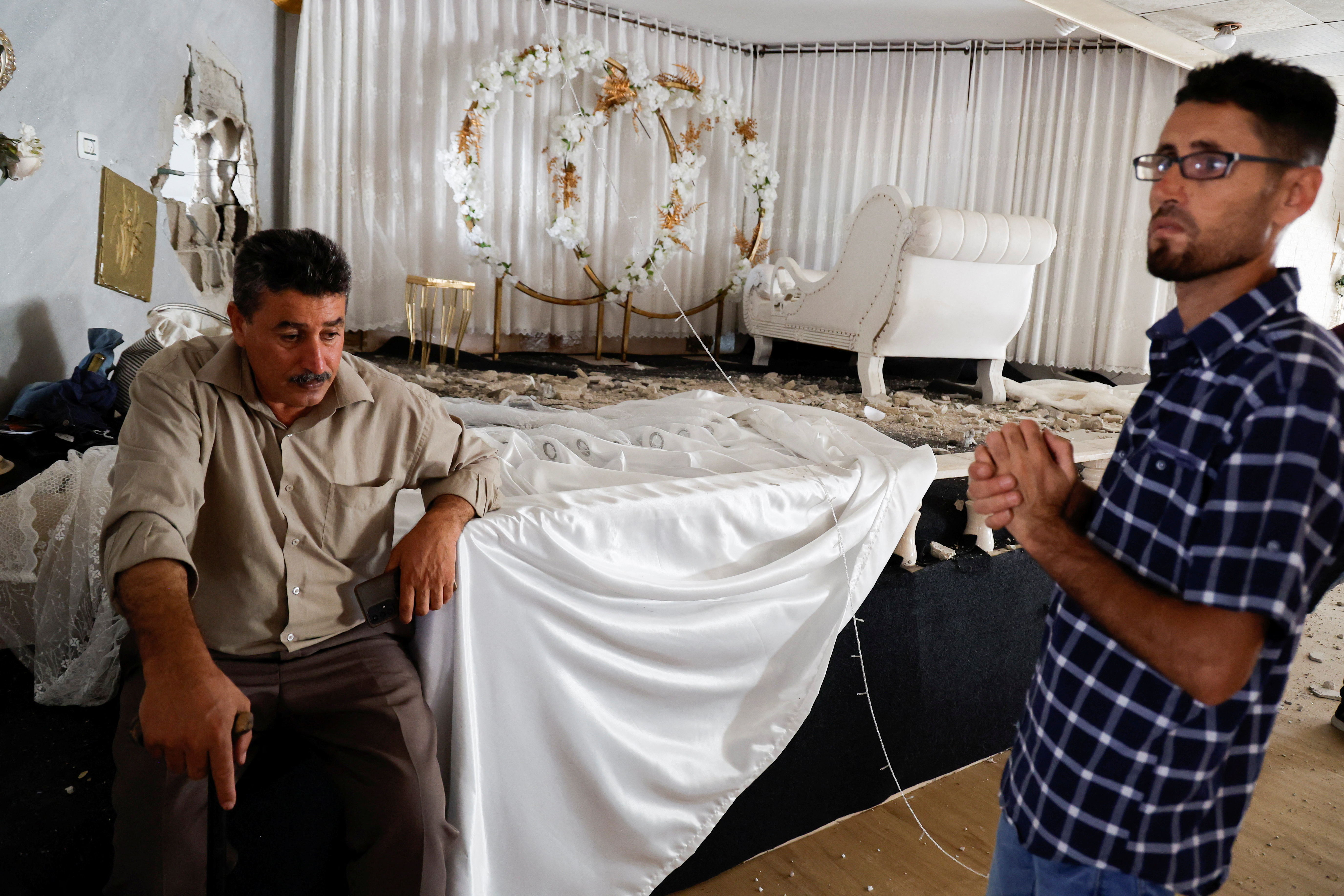 Palestinians inspect the wedding hall that was destroyed by Israeli missiles in the town of Aqaba in the Israeli-occupied West Bank on September 1, 2023