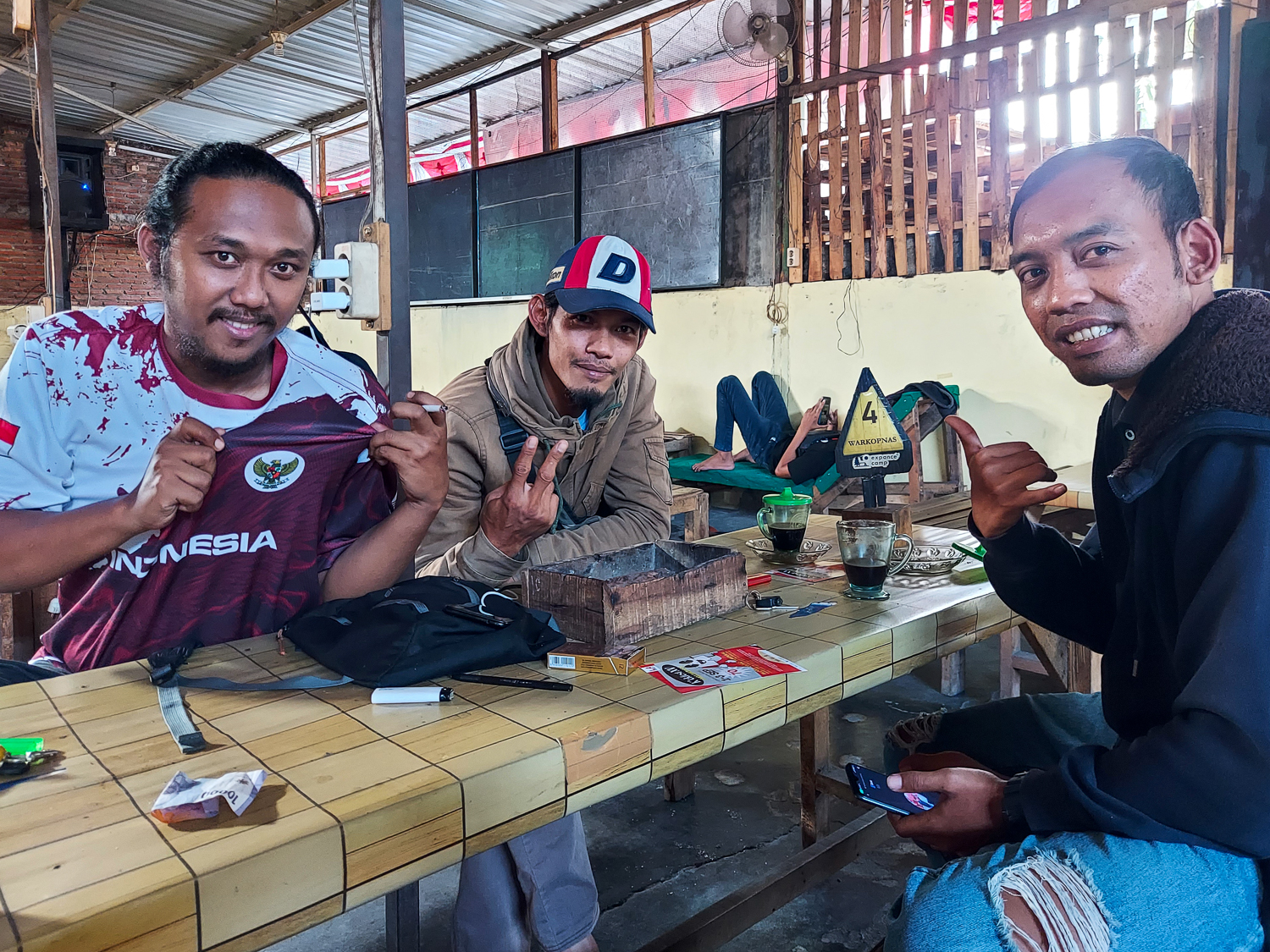 Sandi shows off his Indonesian national team shirt with Angga (right) and Adi (far right).
