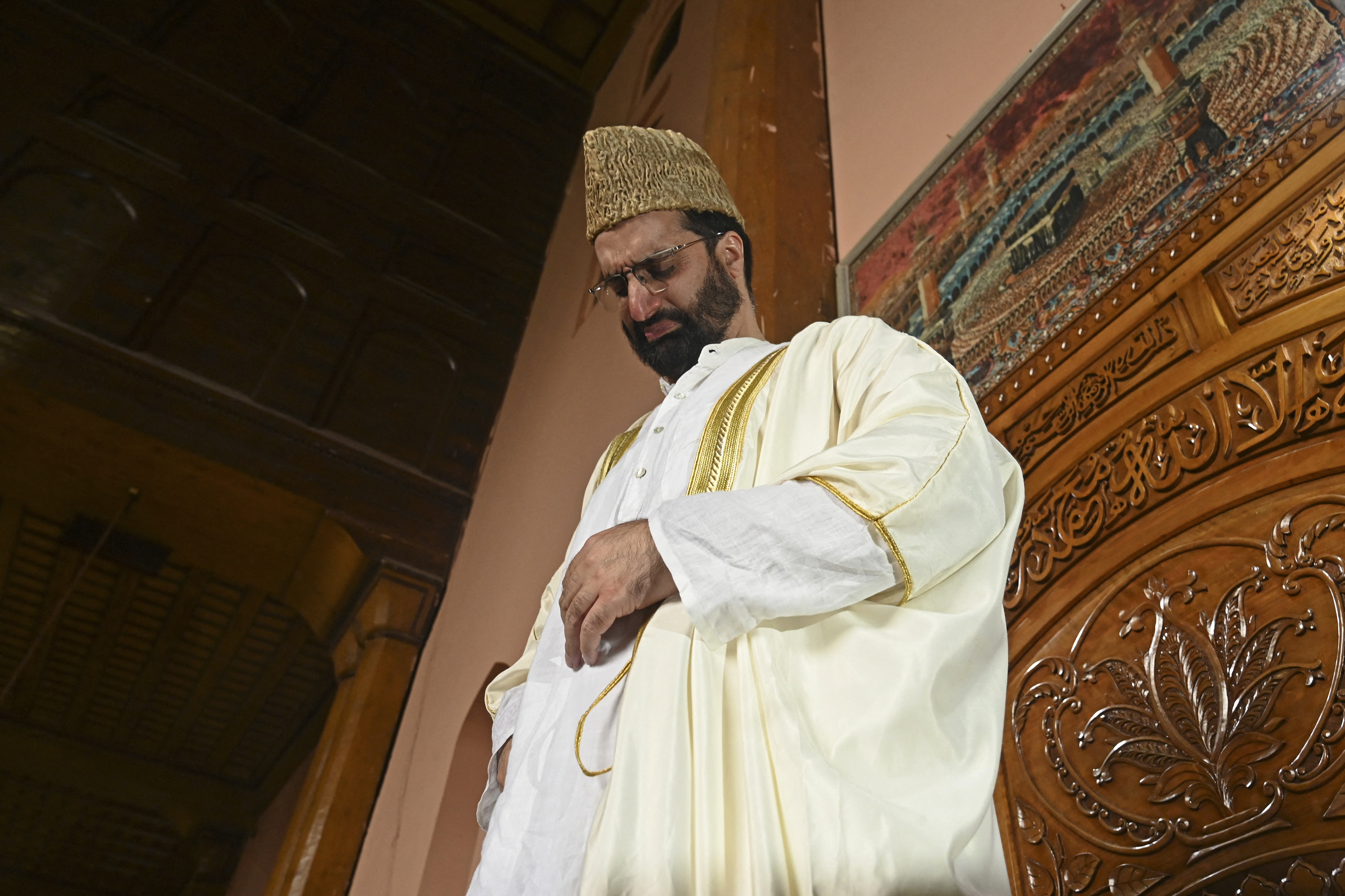 Senior separatist leader Mirwaiz Umar Farooq released after four years of house arrest, weeps before delivering the friday sermon at Jamia Masjid