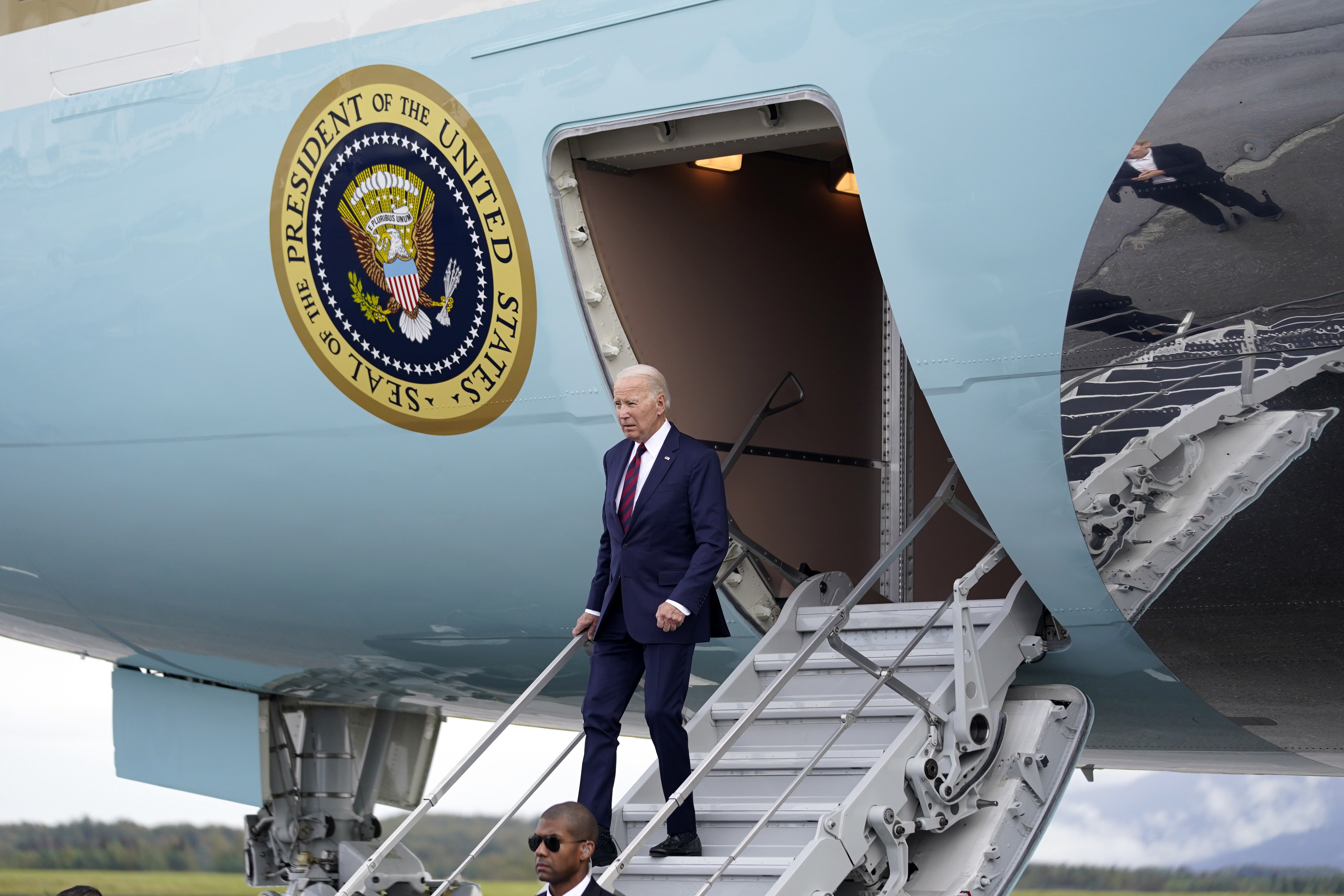Joe Biden walks down the steps of Air Force One plane.