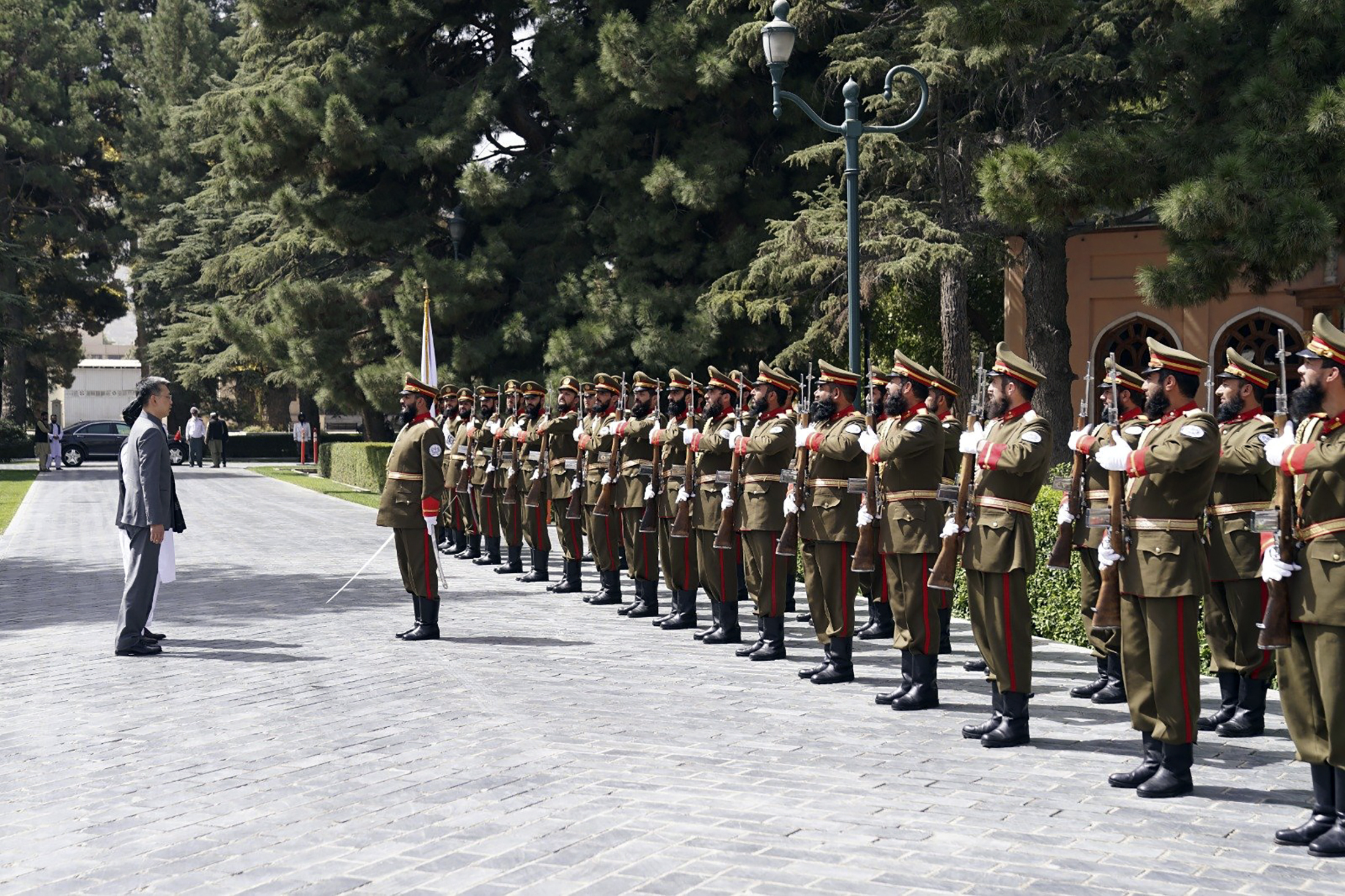 China’s new ambassador to Afghanistan Zhao Sheng, left, reviews an honor guard [Taliban Prime Minister Media Office via AP Photo]