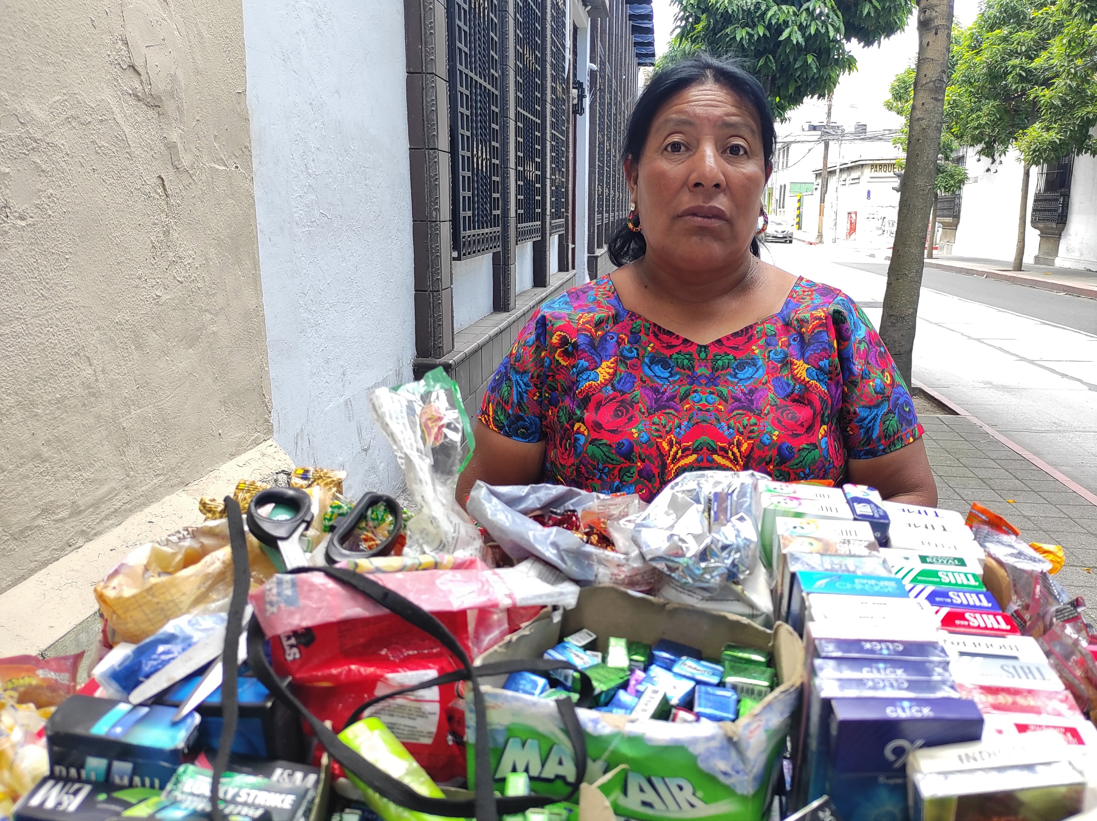 A woman sells good from a cart in Guatemala City