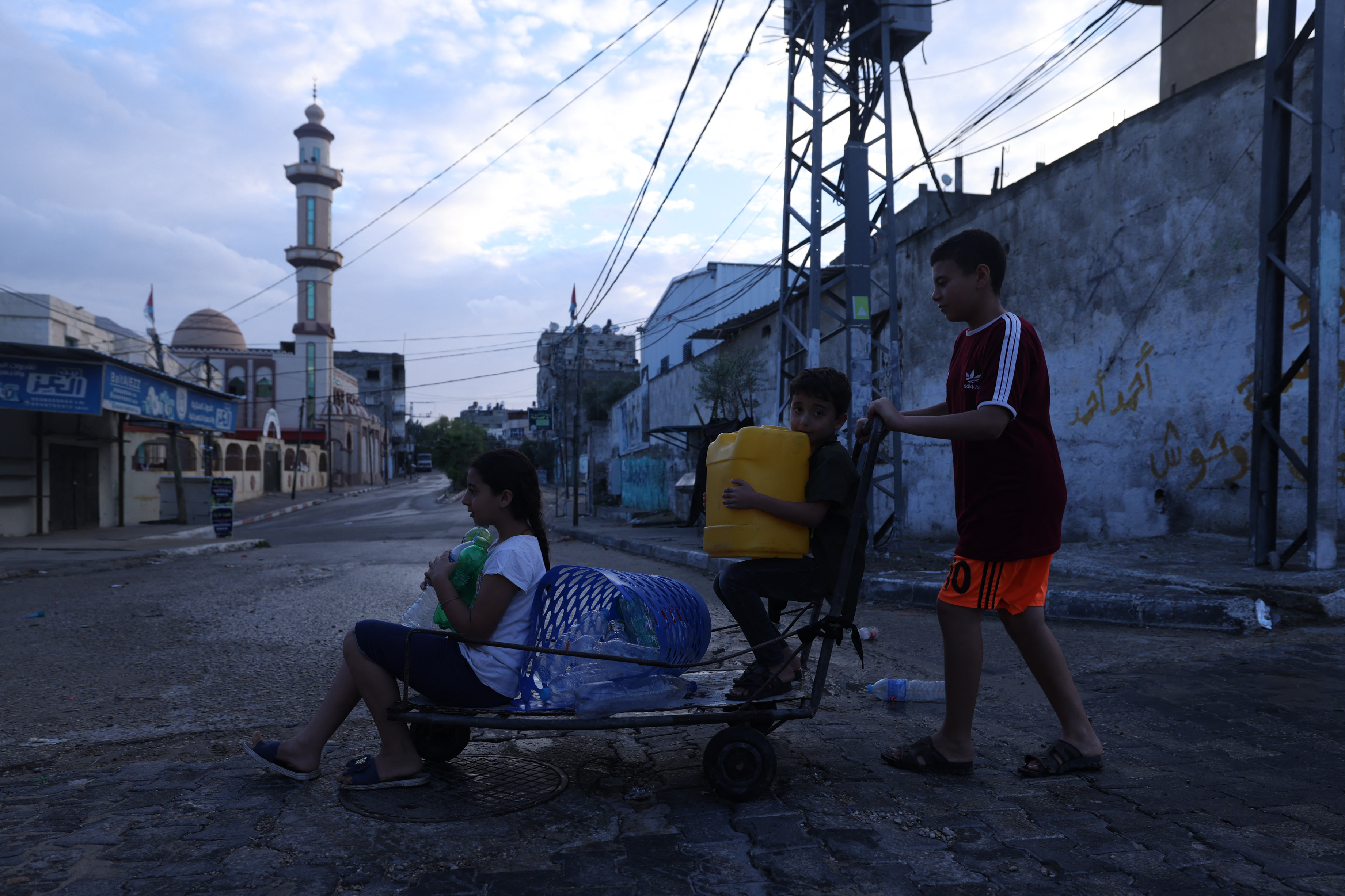 Palestinian children search for a place to refill on water in the Rafah refugee camp, in the southern Gaza Strip