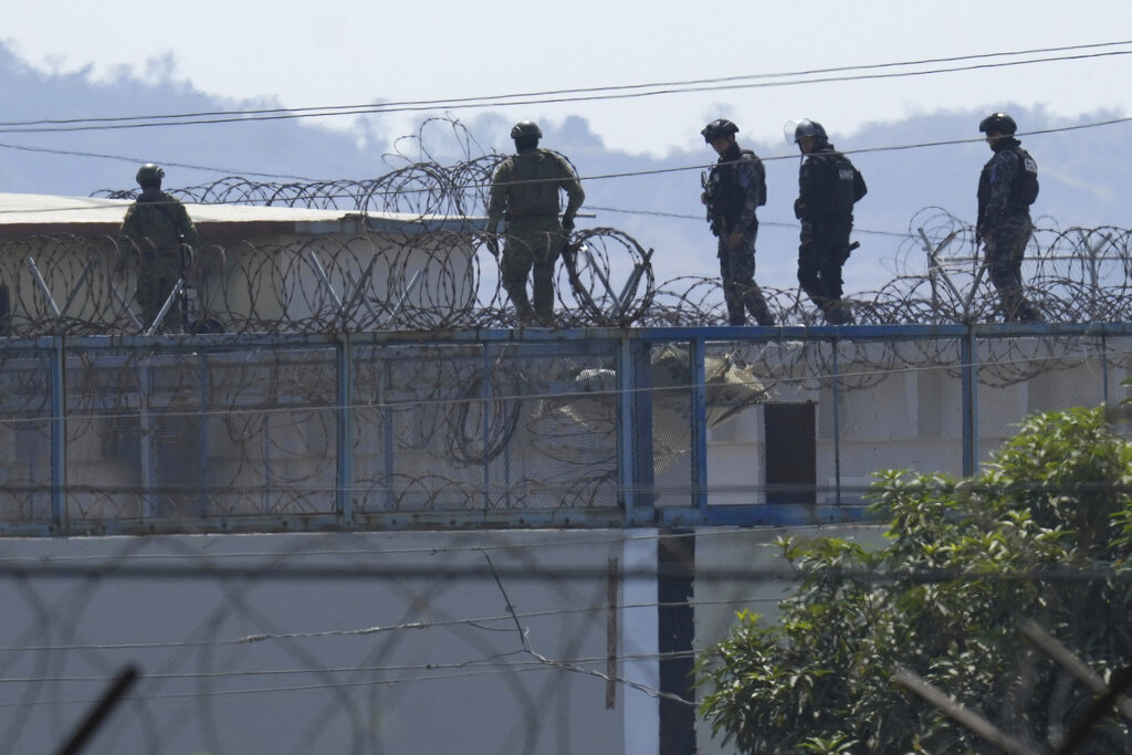 Police walk on top of Litoral Penitentiary amid days of deadly clashes inside the prison, triggered by the transfer of hundreds of inmates in Guayaquil, Ecuador, Friday, Nov. 4, 2022. (AP Photo/Dolores Ochoa)