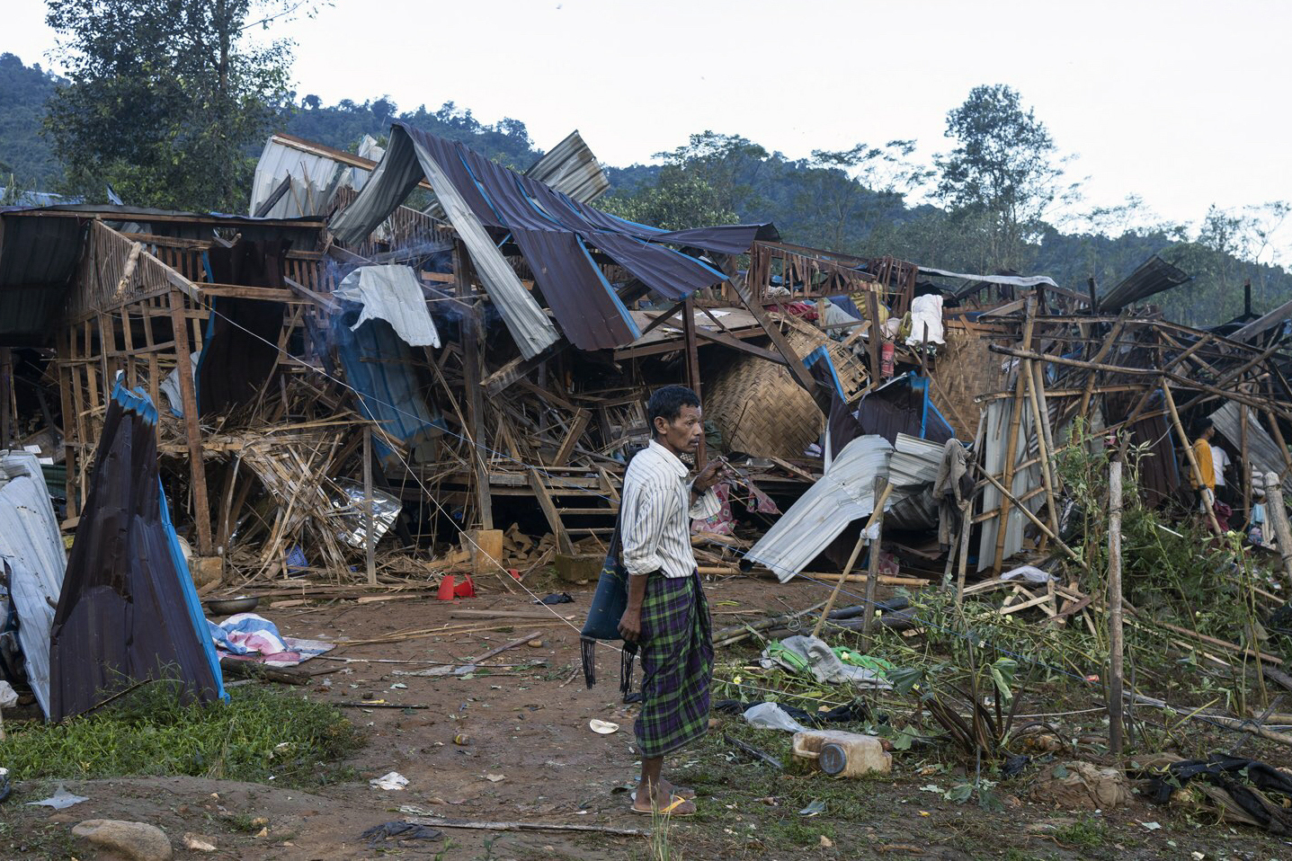 A man looking at homes destroyed in military attacks in northern Kachin state