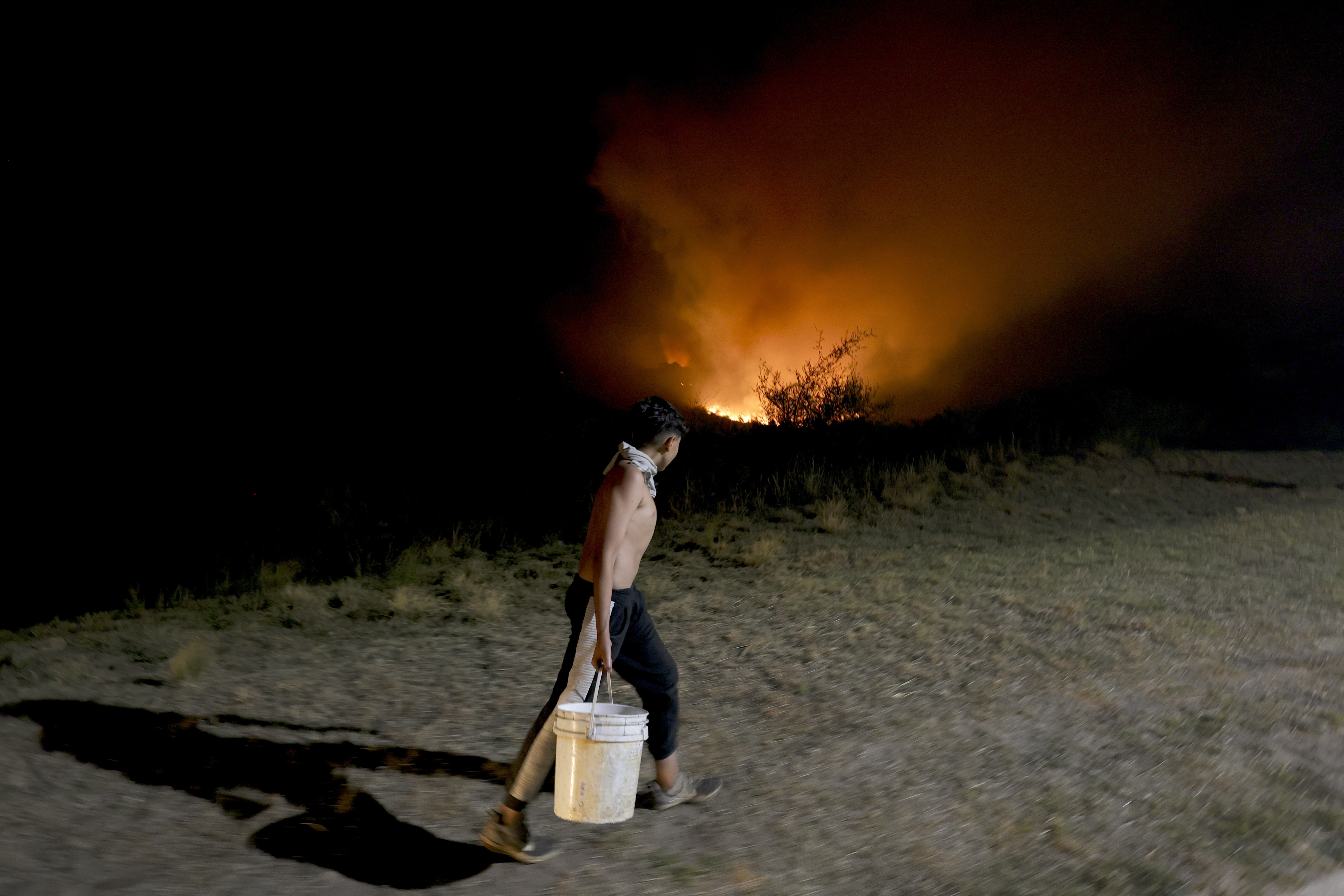 Firefighters work to put out a forest fire