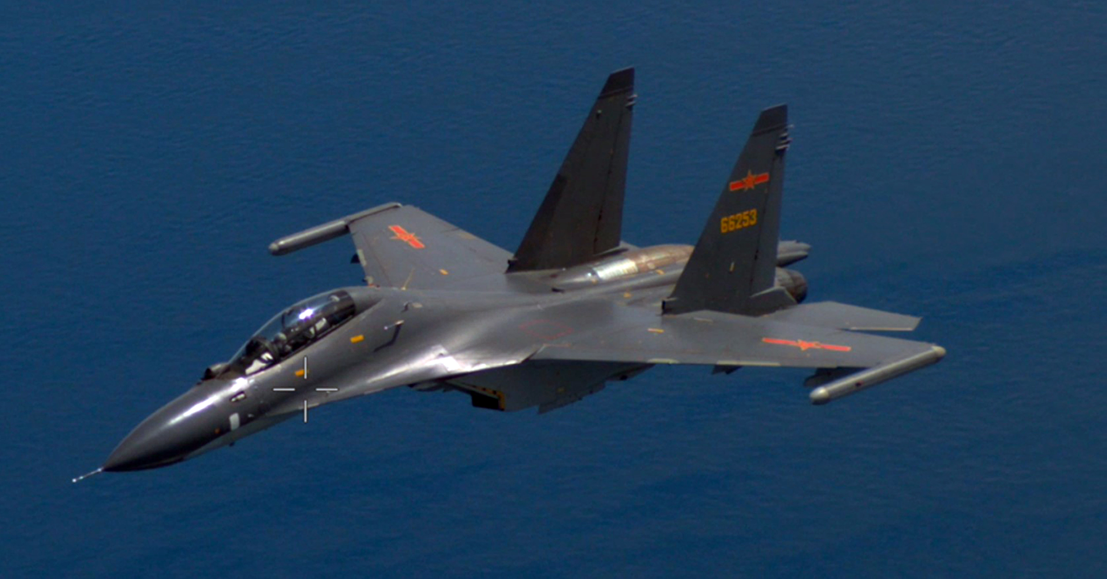 A Chinese fighter jet pictured from a US plane over the Pacific