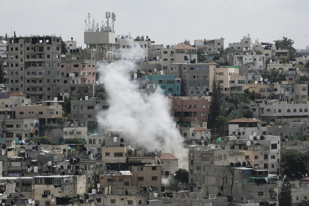 Smoke rises from a Palestinian refugee camp