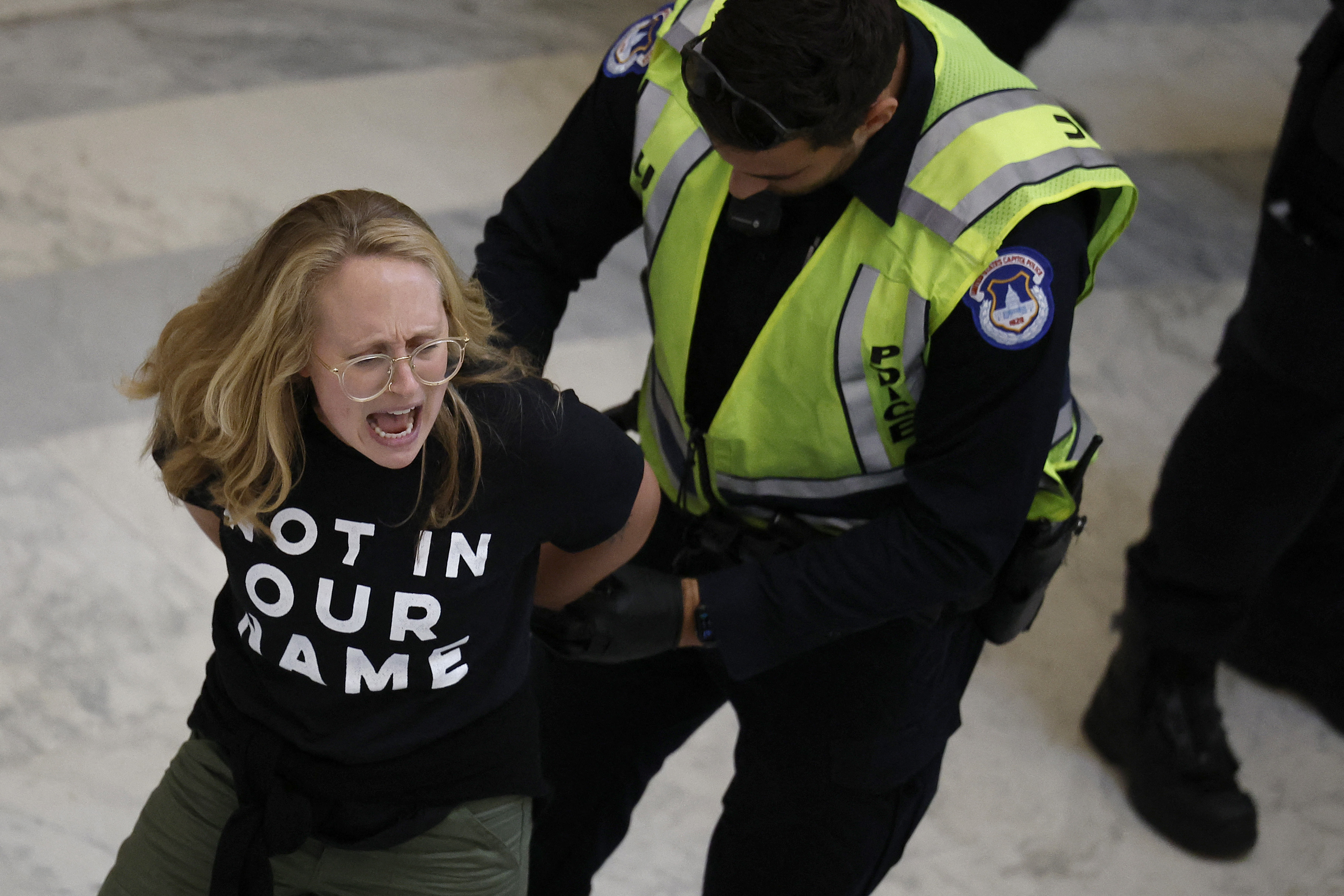 A demonstrator is detained by US Capitol Police for holding a rally to demand a ceasefire against Palestinians in Gaza in the rotunda of the Cannon House Office Building on Capitol Hill on October 18, 2023 in Washington, DC. (Chip Somodevilla/Getty Images/AFP)