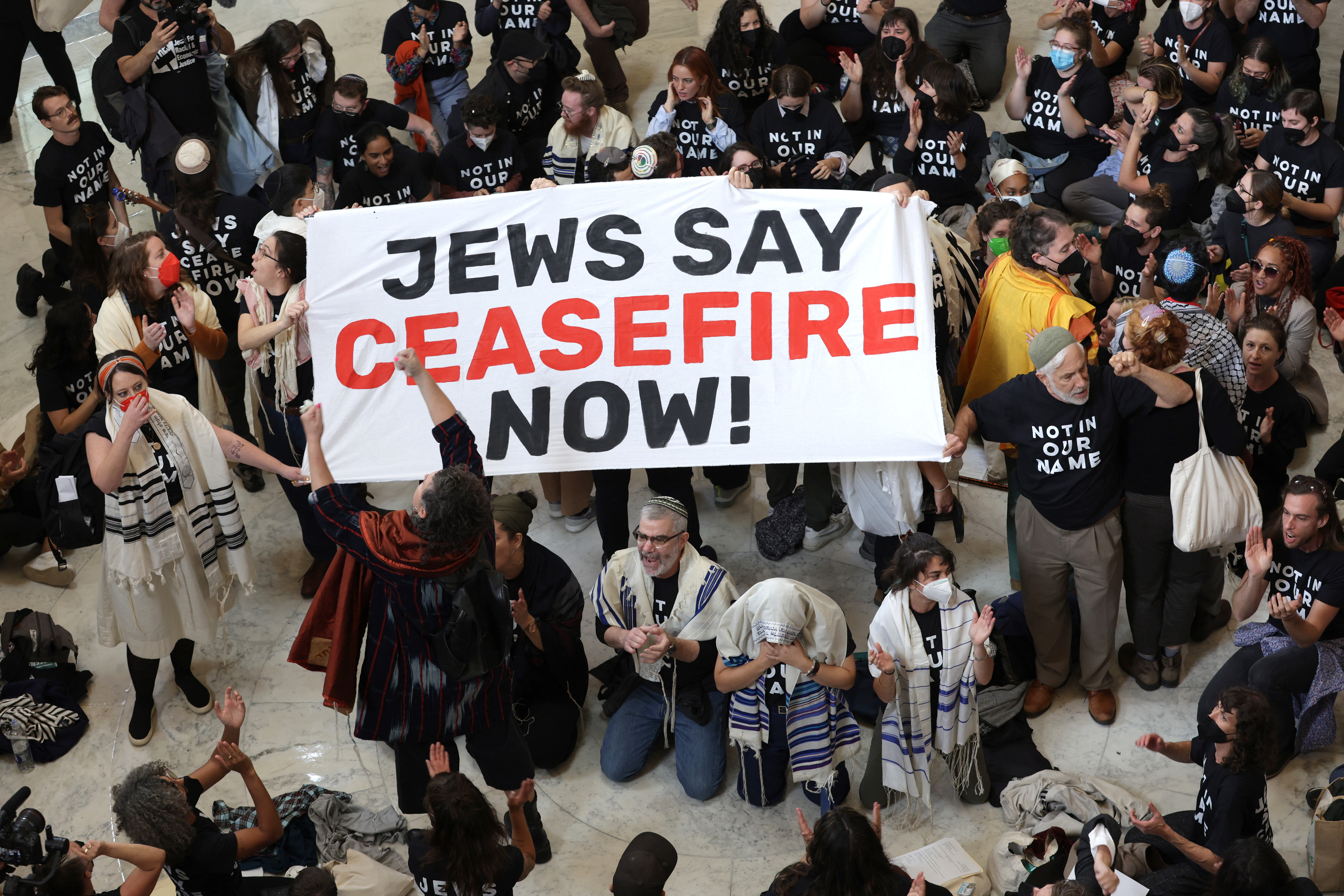 WASHINGTON, DC - OCTOBER 18: Protesters hold a demonstration in support of a cease fire in Gaza in the Cannon House Office Building on October 18, 2023 in Washington, DC. Members of the Jewish Voice for Peace and the IfNotNow movement staged a rally to call for a cease fire in the IsraelHamas war. Alex Wong/Getty Images/AFP (Photo by ALEX WONG / GETTY IMAGES NORTH AMERICA / Getty Images via AFP)