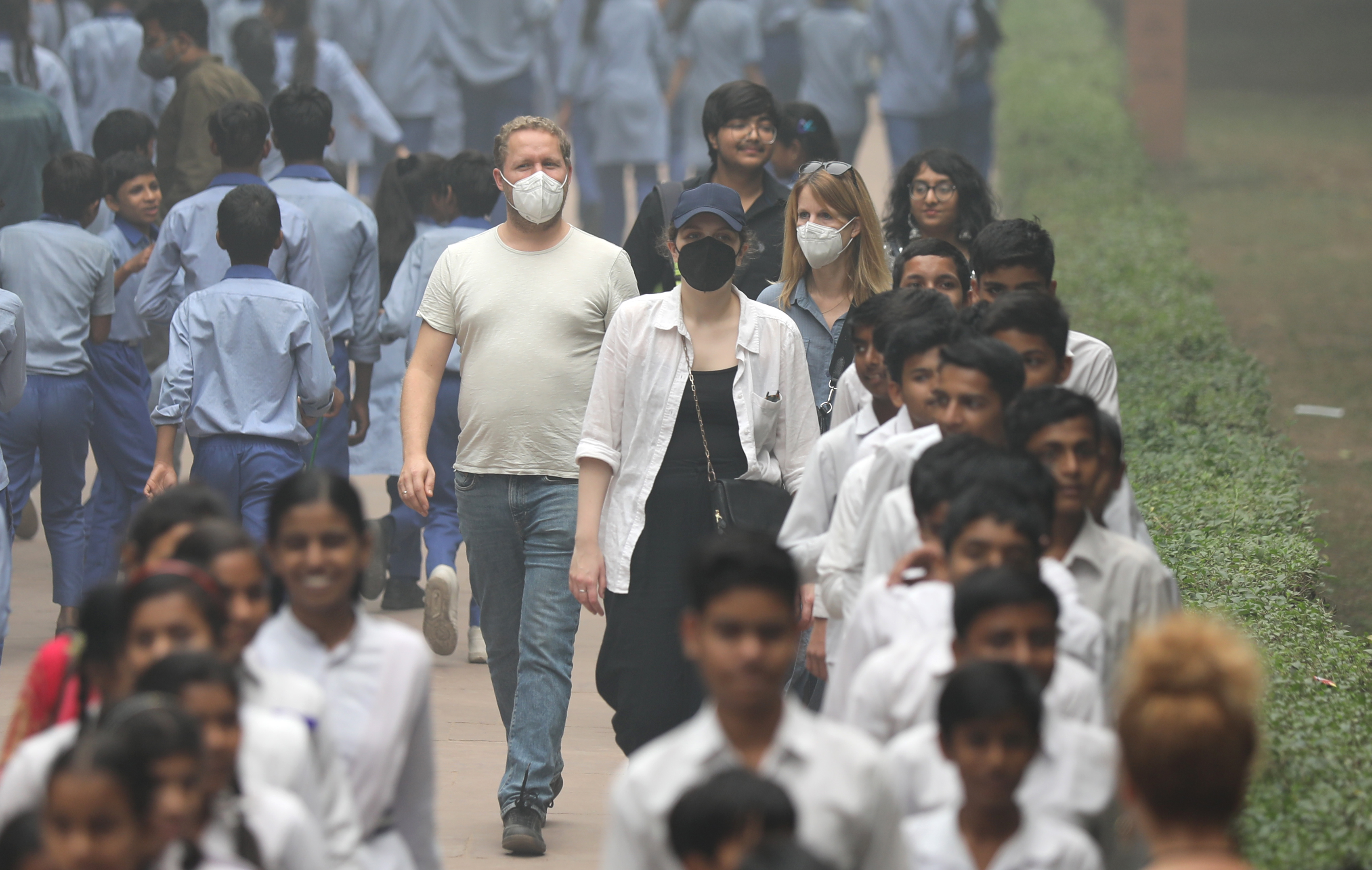 Tourists wear face masks as the city is engulfed in heavy smog at Humayun's Tomb in New Delhi