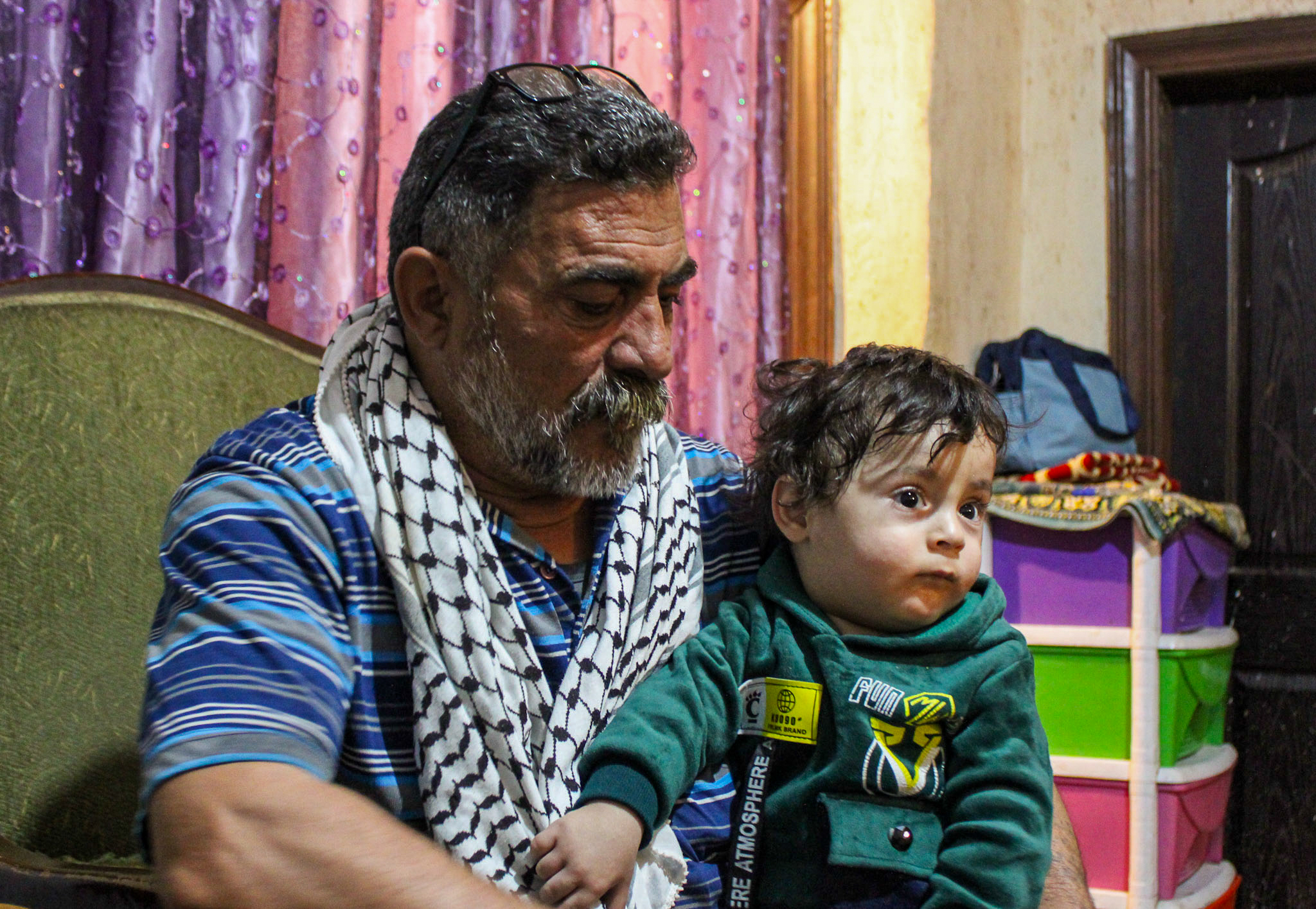 Saadi Nashwan holds his grandson, Tayem