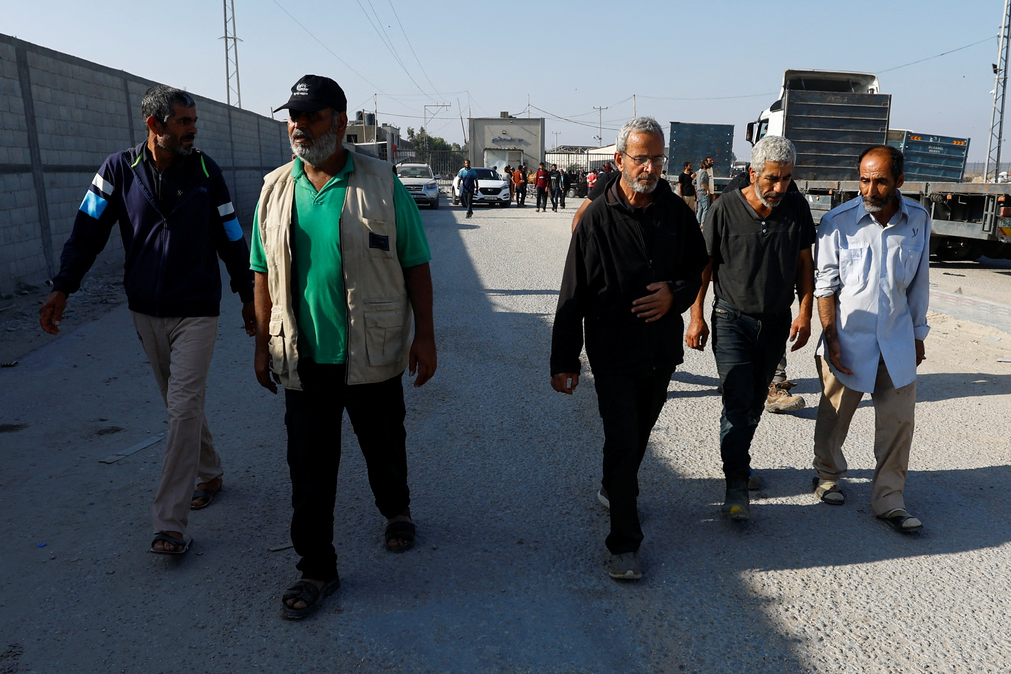 Palestinian labourers, who were in Israel during the Hamas October 7 attack, arrive at the Rafah border after being sent back by Israel to the strip, in the southern Gaza Strip.
