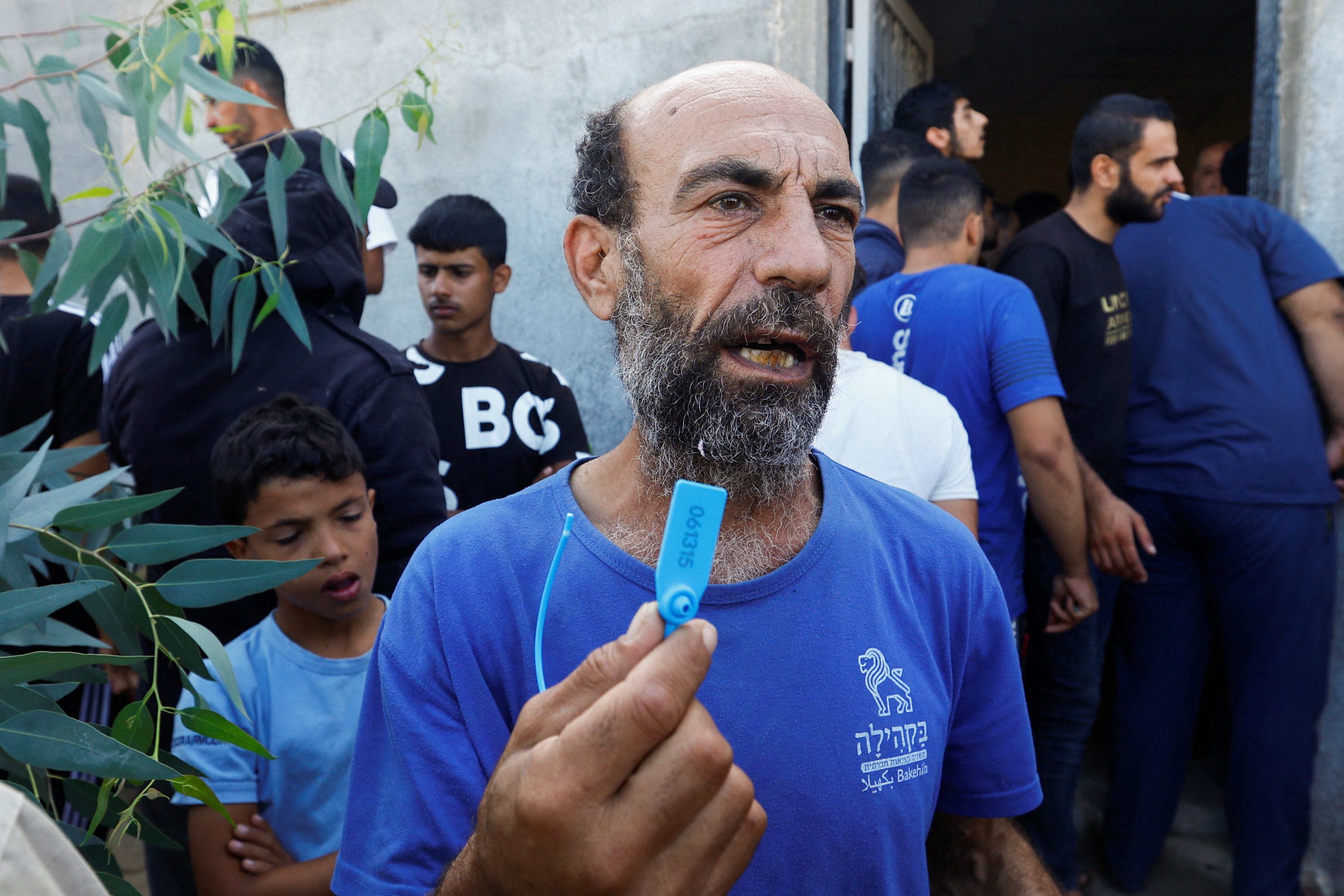 A Palestinian worker, one of the workers who were in Israel during the Hamas October 7 attack, gestures as he arrives at the Rafah border after being sent back by Israel to the strip, in the southern Gaza Strip.
