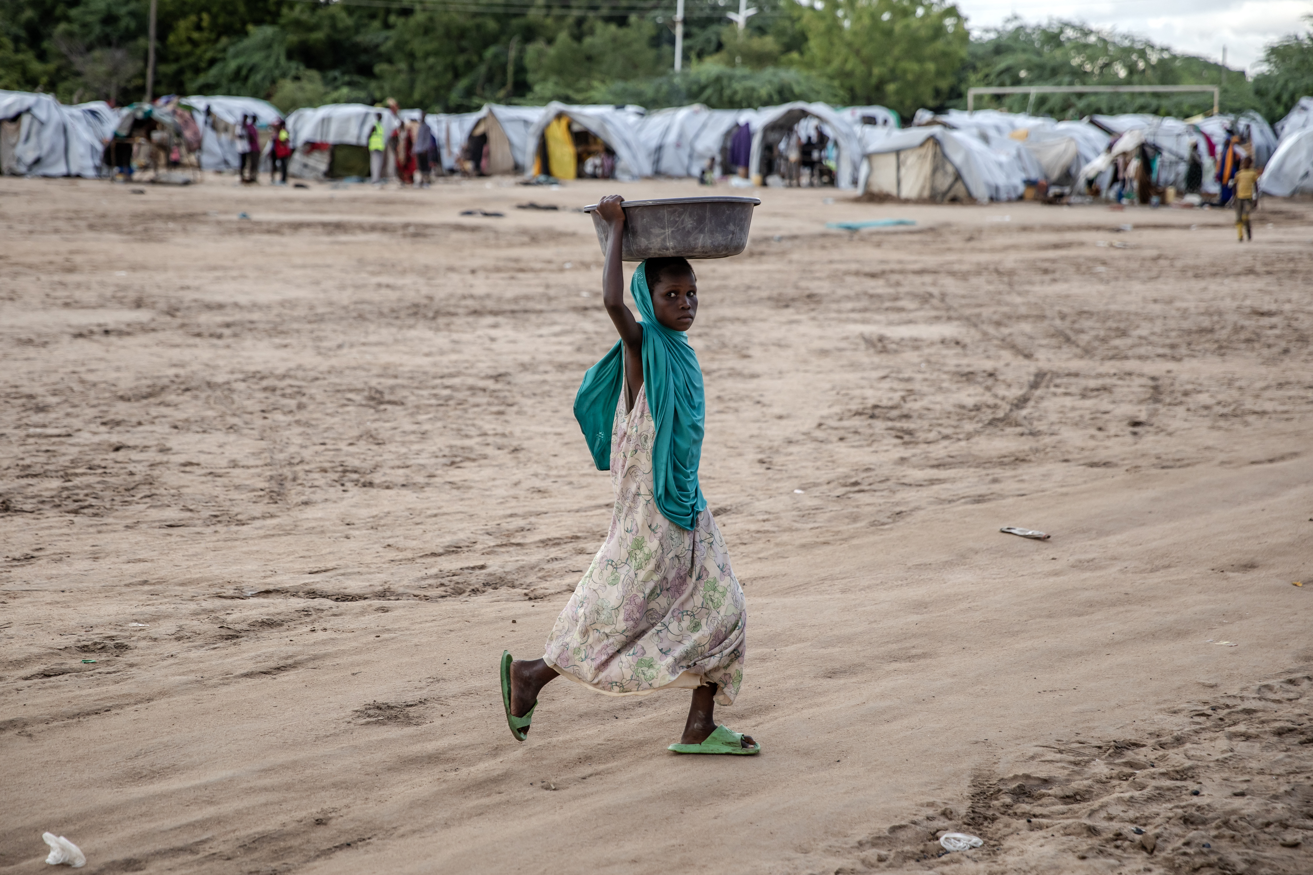 A girl carries goods at an internally displaced persons (IDP) camp for families displaced by floods in Garissa.