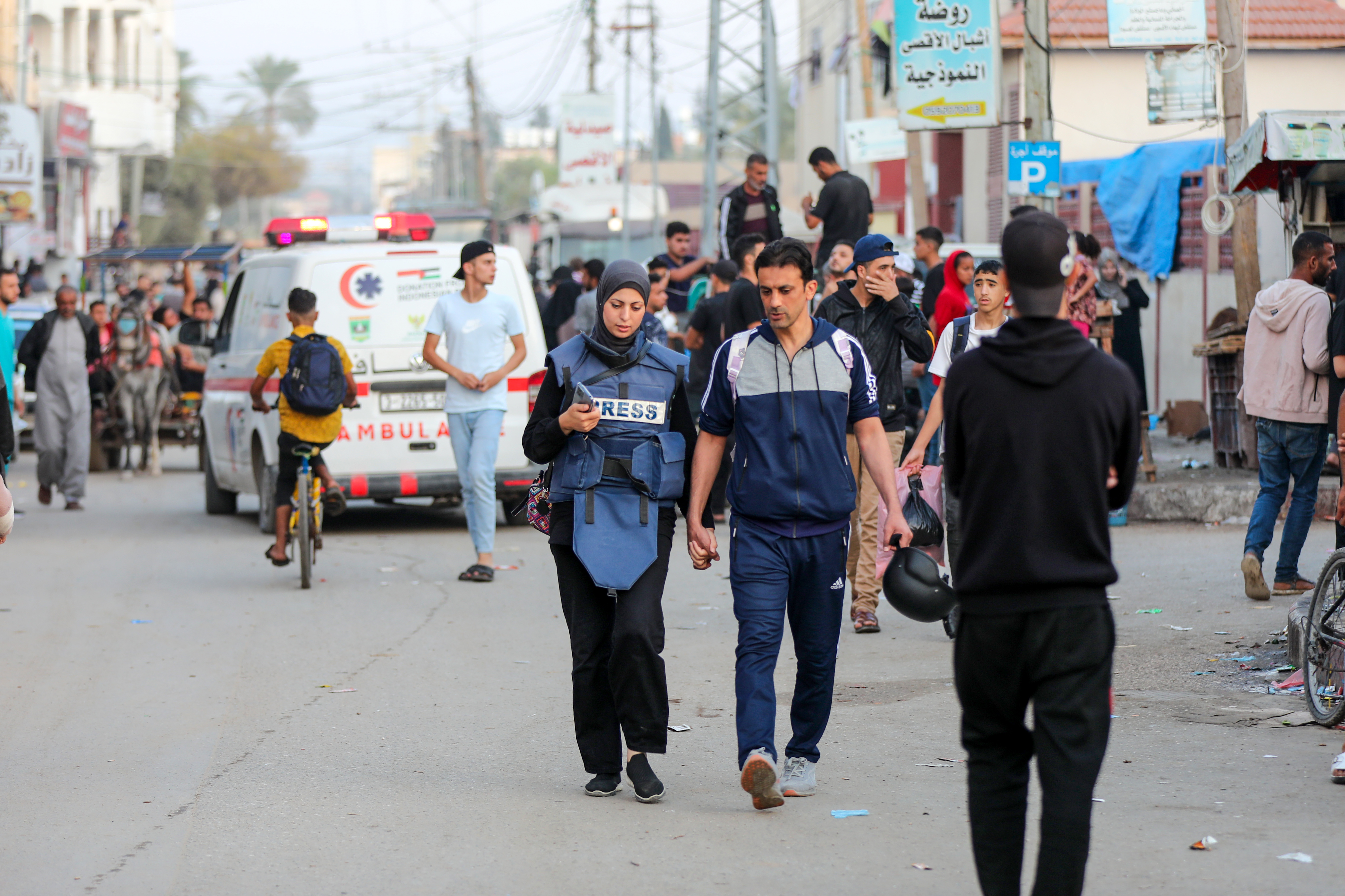 Khawla and her husband, Baher, walk back to the house where they’re staying after she finishes work