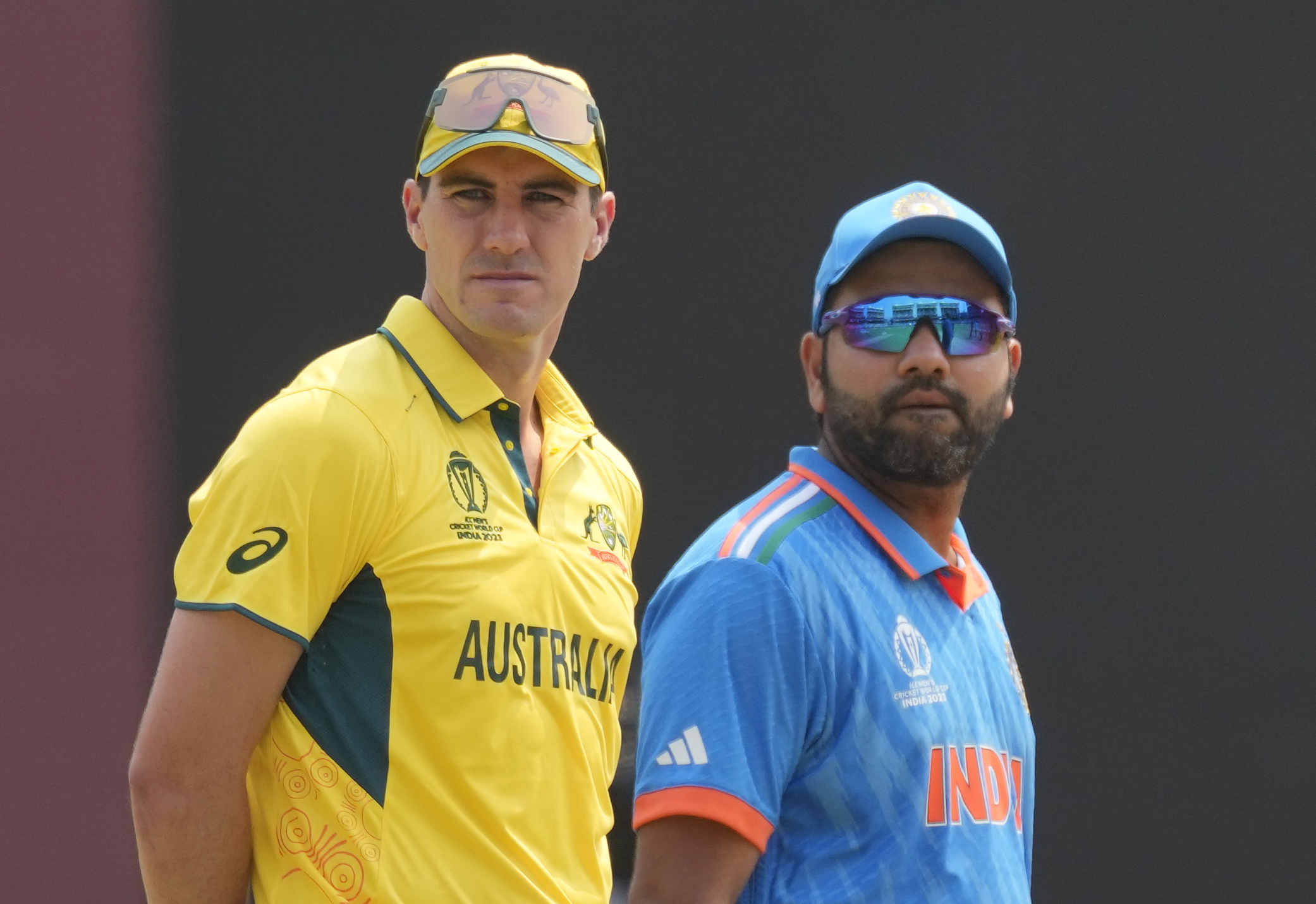 India's captain Rohit Sharma and Australia's captain Pat Cummins stand beside each other for the coin toss