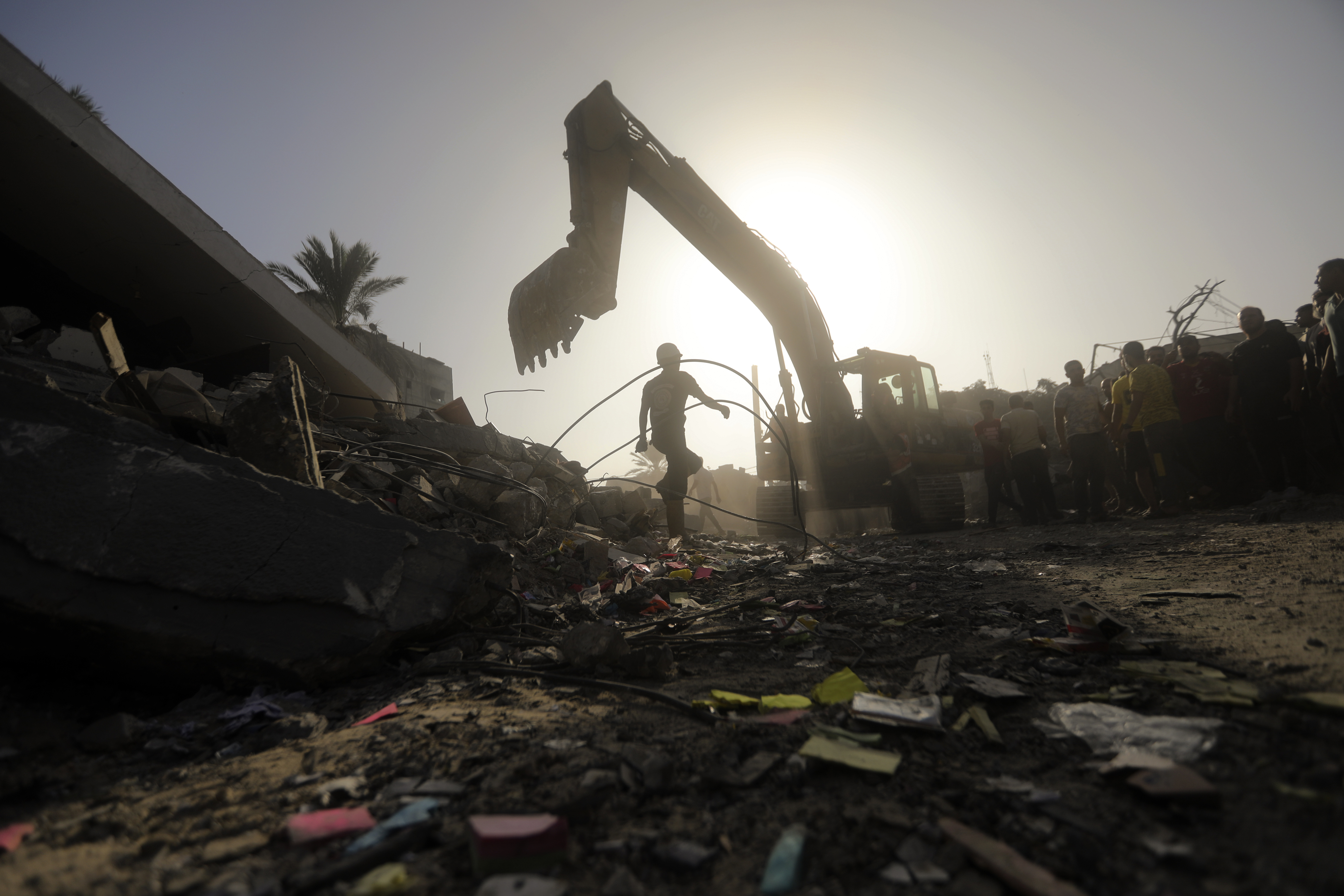 Palestinians look for survivors following an Israeli airstrike in Khan Younis refugee camp, southern Gaza Strip.
