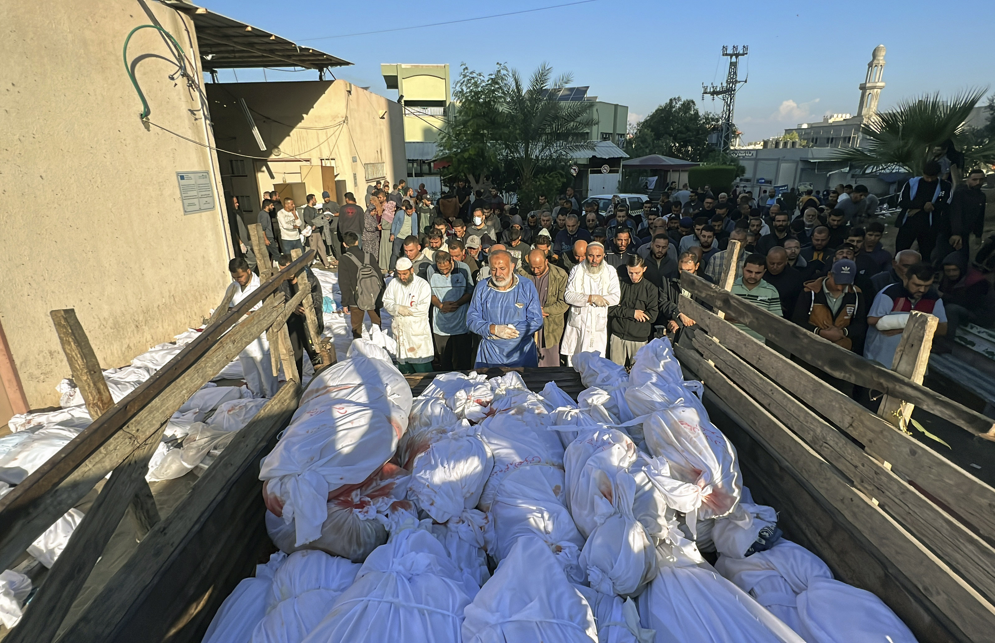 Palestinians pray over the bodies of people killed by Israeli airstrikes on Jabaliya refugee camp, at the Indonesian hospital, northern Gaza Strip.