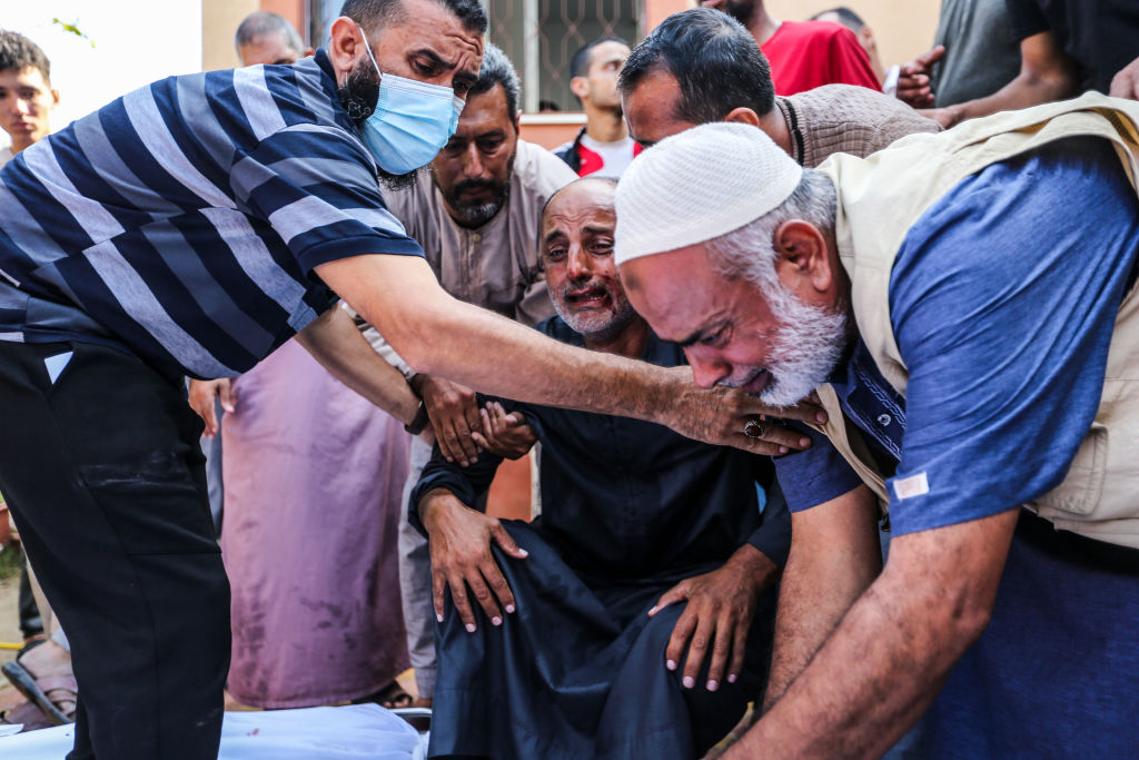 People mourn as they collect the bodies of Palestinians killed in Israeli air raids on in Khan Yunis, Gaza.