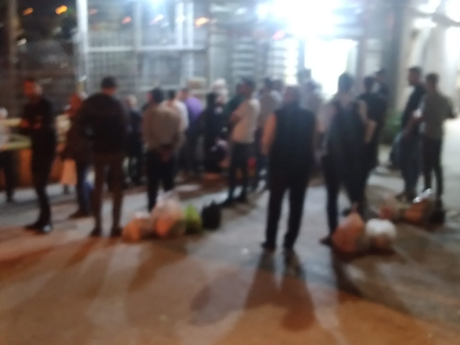 Blurry view of people lined up at a checkpoint