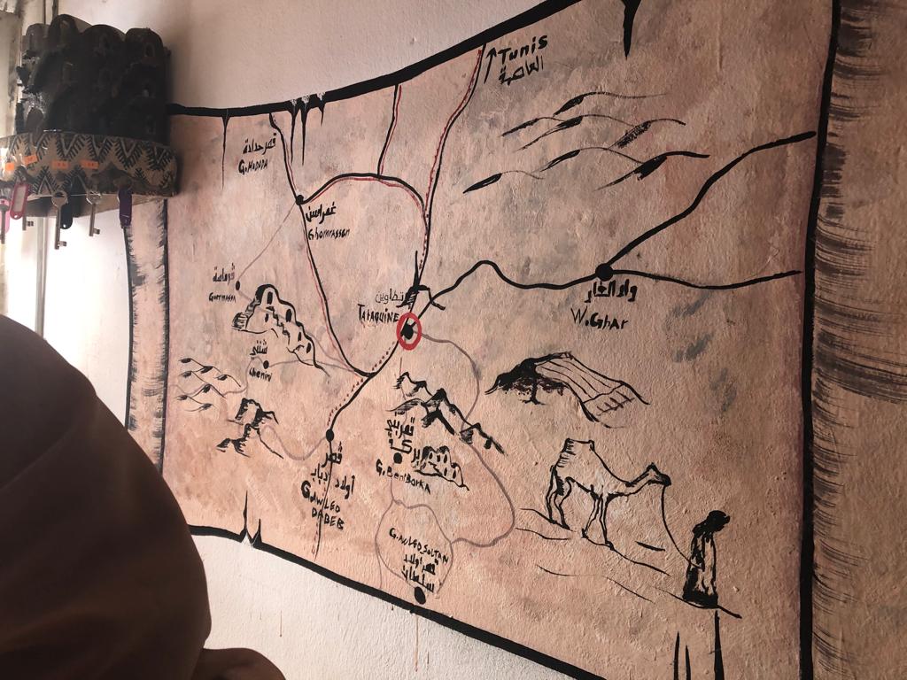 A photo of a large fabric map on a wall.