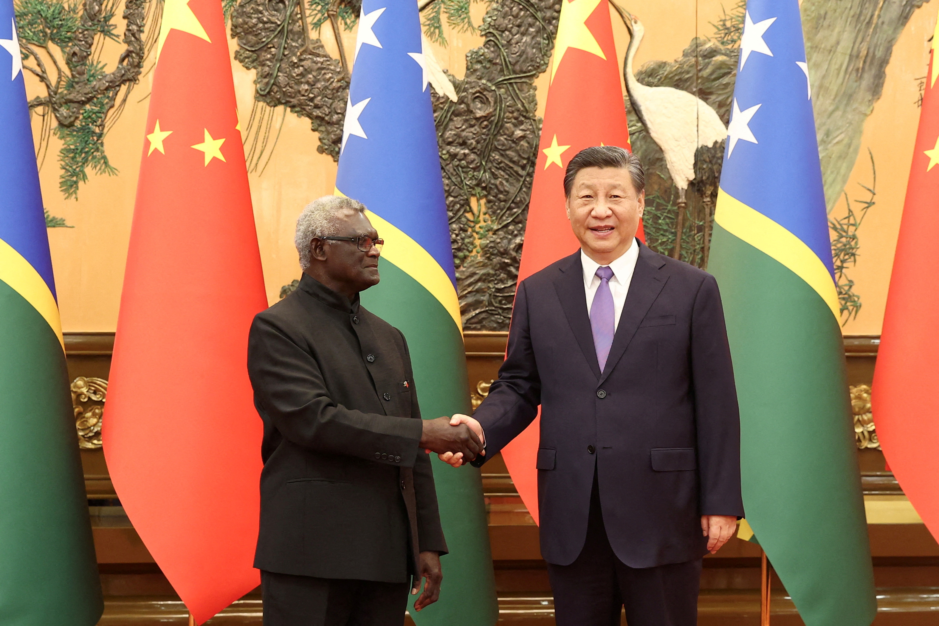 Solomon Islands Prime Minister Manasseh Sogavare (left) has forged closer relations with China and its leader Xi Jinping