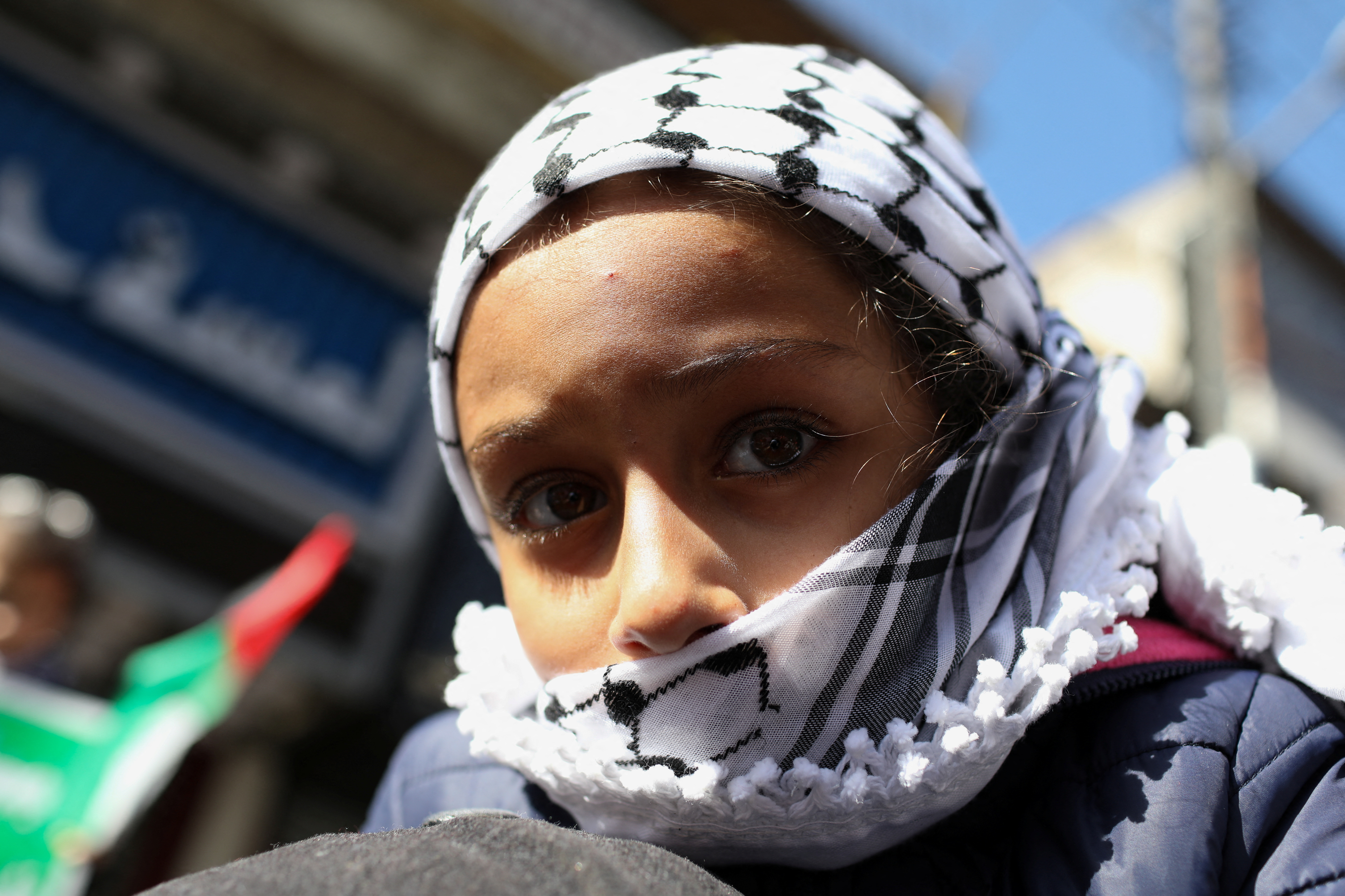 A child looks on during a protest in support of Palestinians in Gaza, in Amman, Jordan December 1