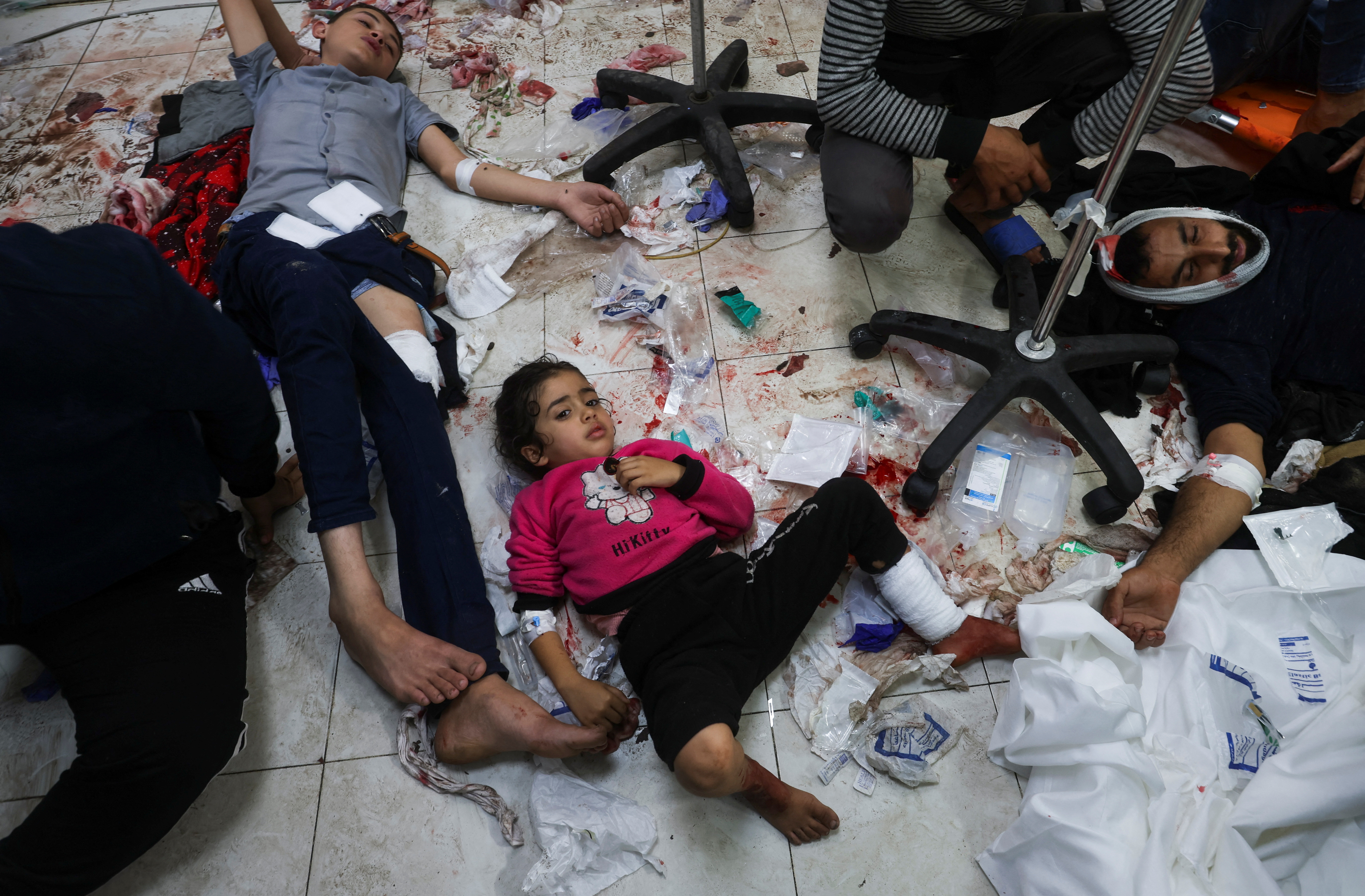 Wounded Palestinians lie on the floor at Nasser hospital