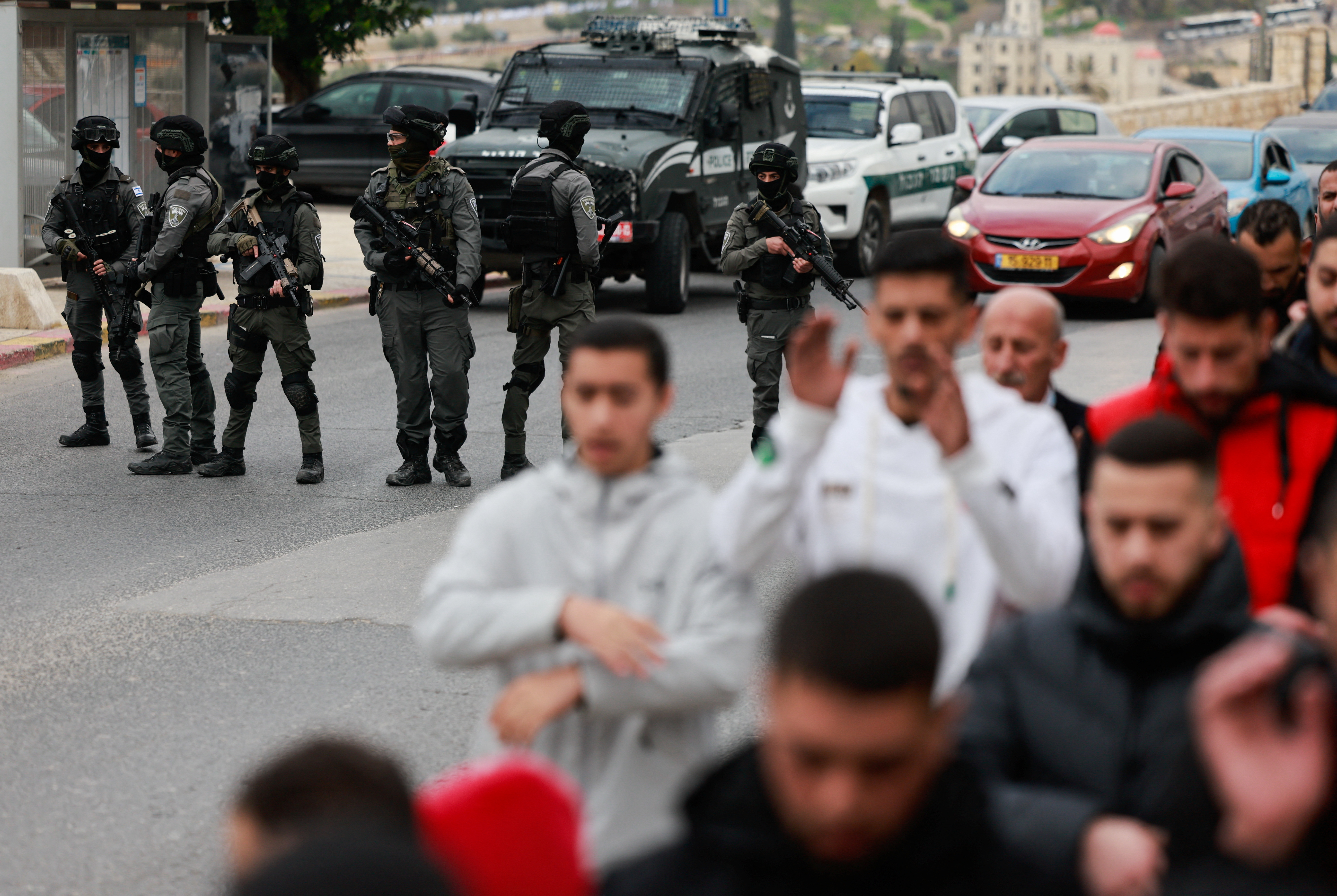 Israeli Border Police officers stand guard, while Palestinian Muslims hold Friday prayers, as the conflict between Israel and the Palestinian Islamist group Hamas continues, in Jerusalem, December 29