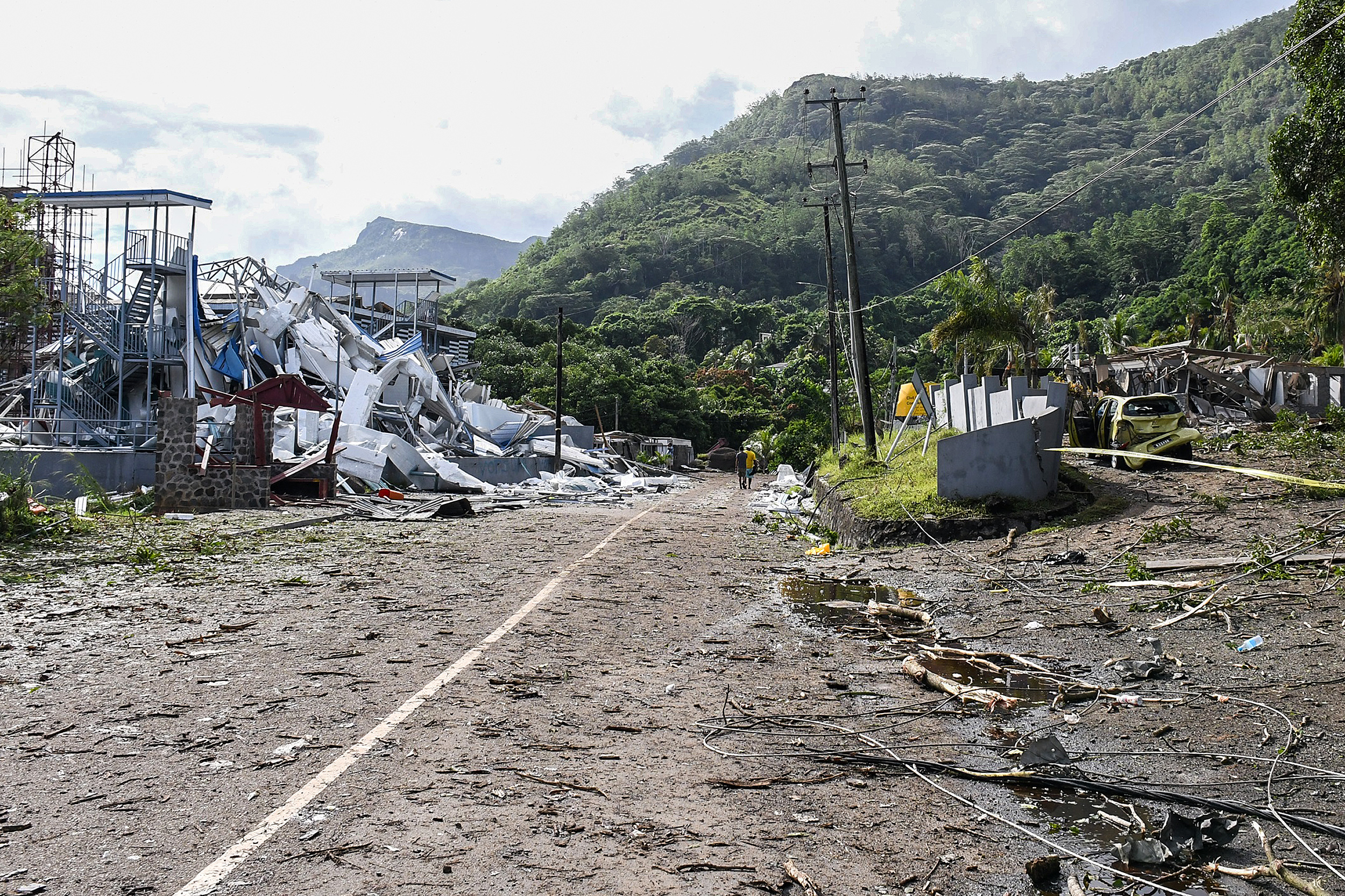 Damaged infrastructure is seen following an explosion at the Providence industrial area in Mahe on December 7, 2023. - Seychelles President Wavel Ramkalawan declared a state of emergency on December 7, 2023, ordering citizens to stay at home after a blast at an explosives store and flooding due to heavy rain caused massive damage. The explosion happened in an industrial area in Mahe, the largest island in the Indian Ocean archipelago, causing huge damage at the site and to surrounding areas, the presidency said in a statement. (Photo by Mervyn Marie / AFP) (AFP)