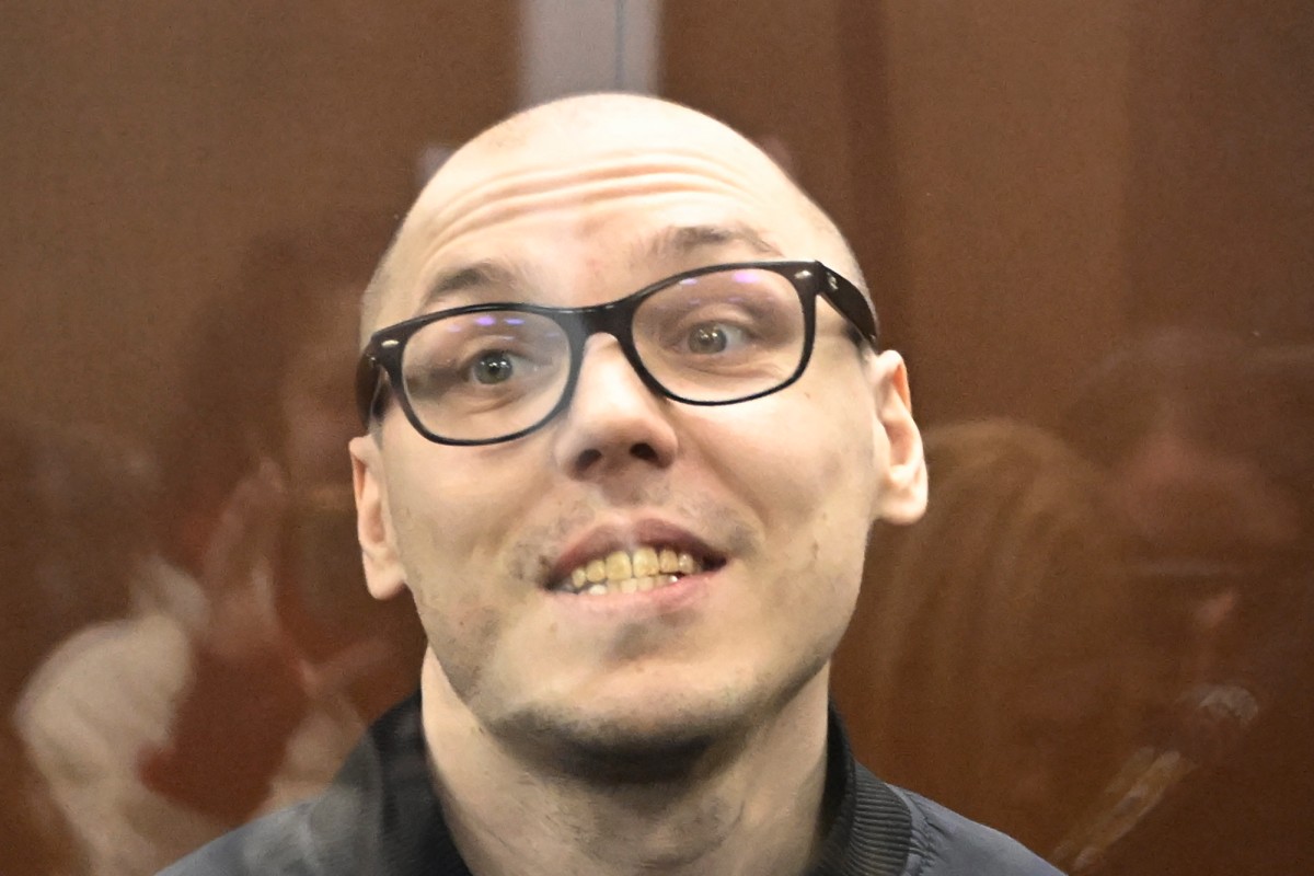 Russian poet Artyom Kamardin stands inside the defendants’ glass cage as his sentence is read out in court, on December 28, 2023. He recited his poem, ‘Kill me, militia man!’ at an anti-war rally last year