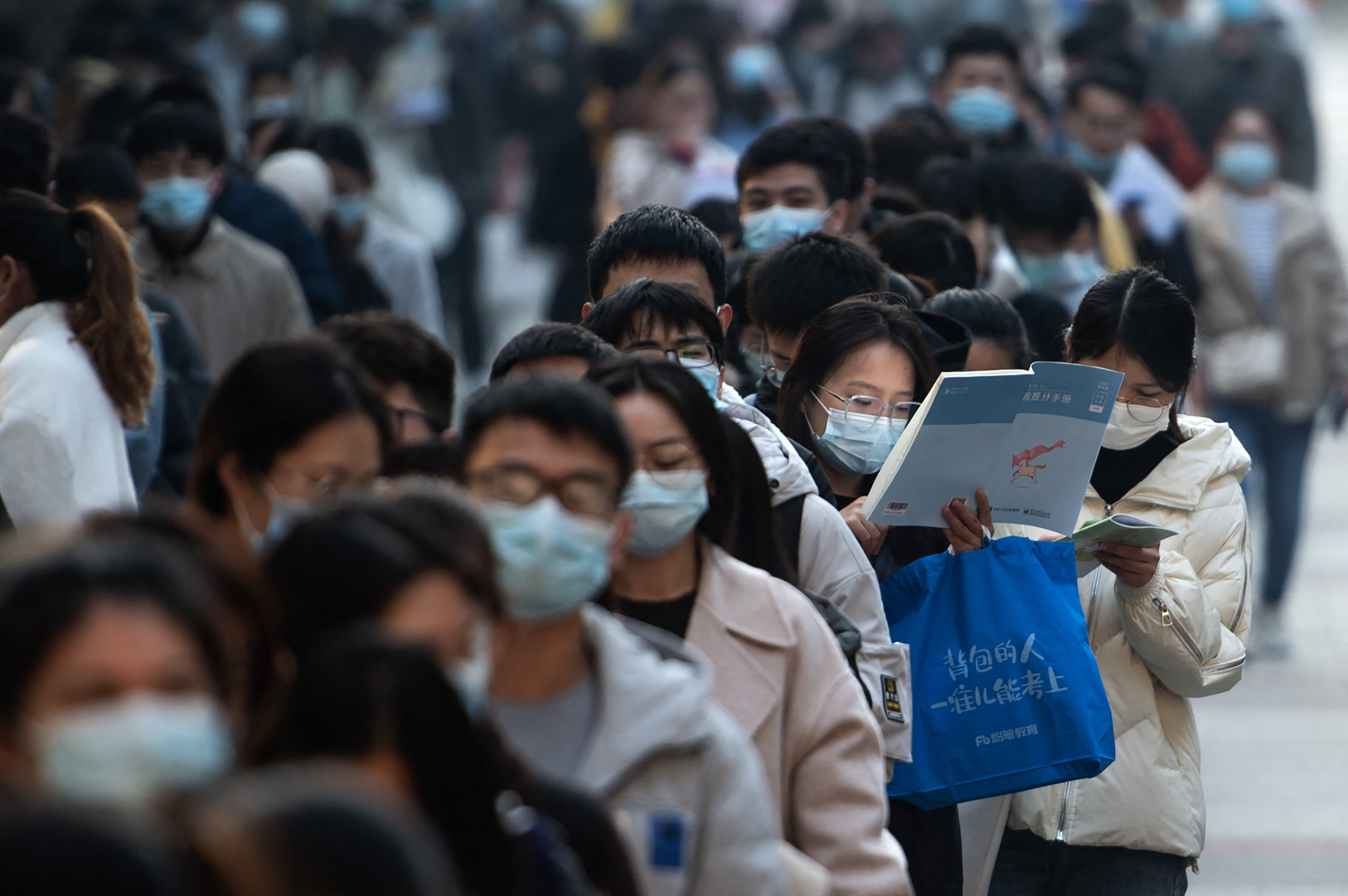 This photo taken on November 28, 2021 shows candidates queueing to take the national examination for admissions to the civil service in Wuhan in China's central Hubei province. (Photo by AFP) / China OUT / CHINA OUT