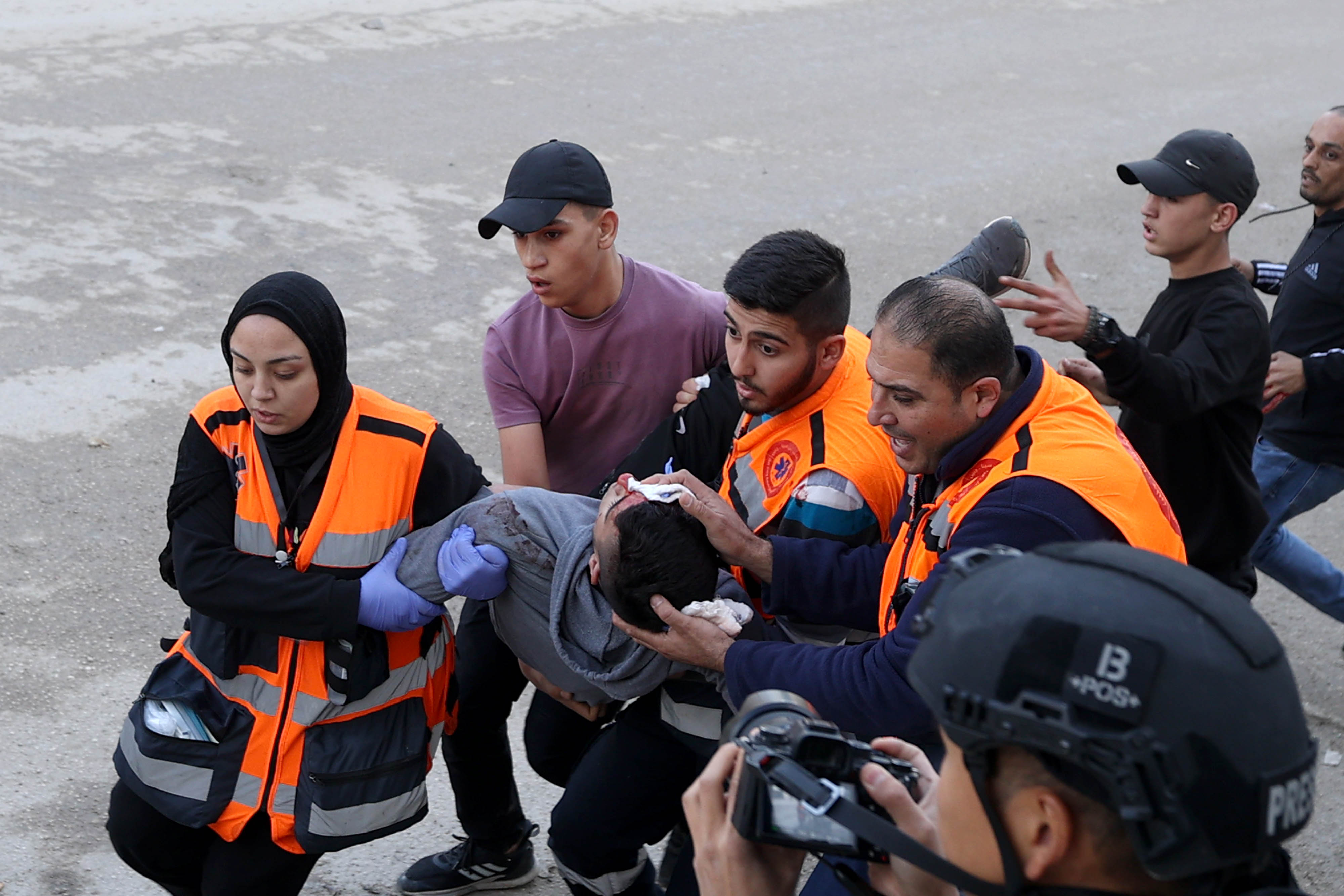 Medical staff carry an injured Palestinian man to an ambulance as Israeli forces raid the Jenin Refugee Camp in the city of Jenin, north of the West Bank.