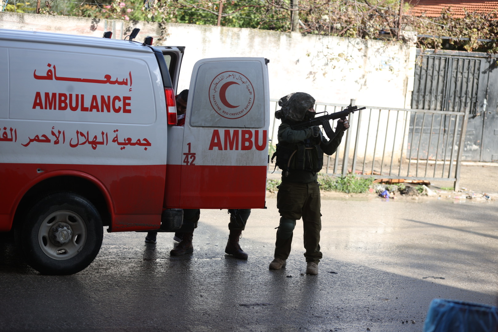 Israeli forces search Palestinian Red Crescent Society ambulances. [Issam Rimawi/Anadolu]