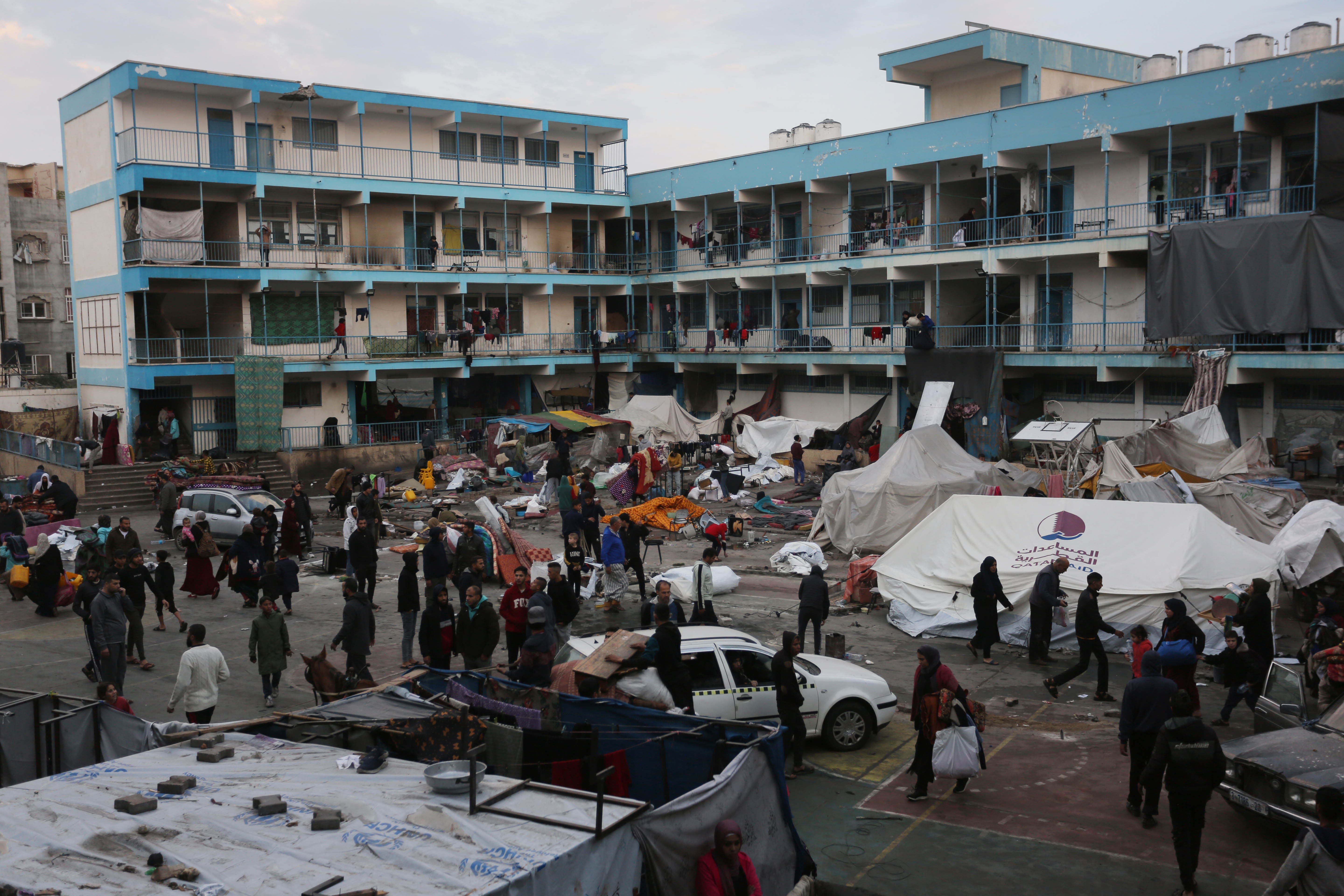 Palestinians gather their belongings and leave the area after Israeli airstrike hit Al-Maghazi School affiliated with UNRWA at Al-Maghazi refugee camp in Gaza Strip.