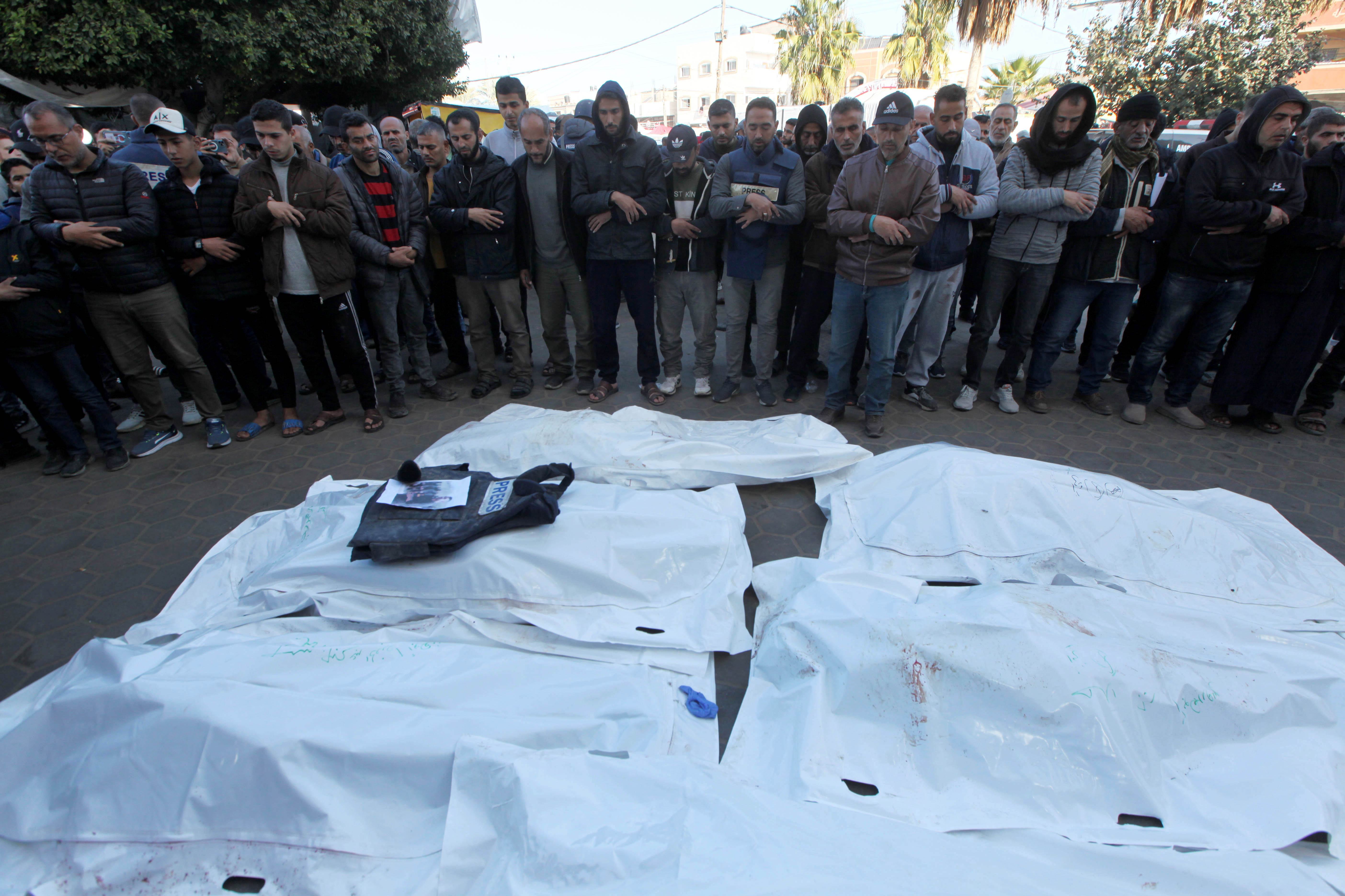 Relatives, colleagues and loved ones of Al-Quds TV journalist Cebr Abu Hedrus', who died in Israeli attacks on Nuseirat refugee camp, attend the funeral ceremony in Deir al-Balah, Gaza on December 30