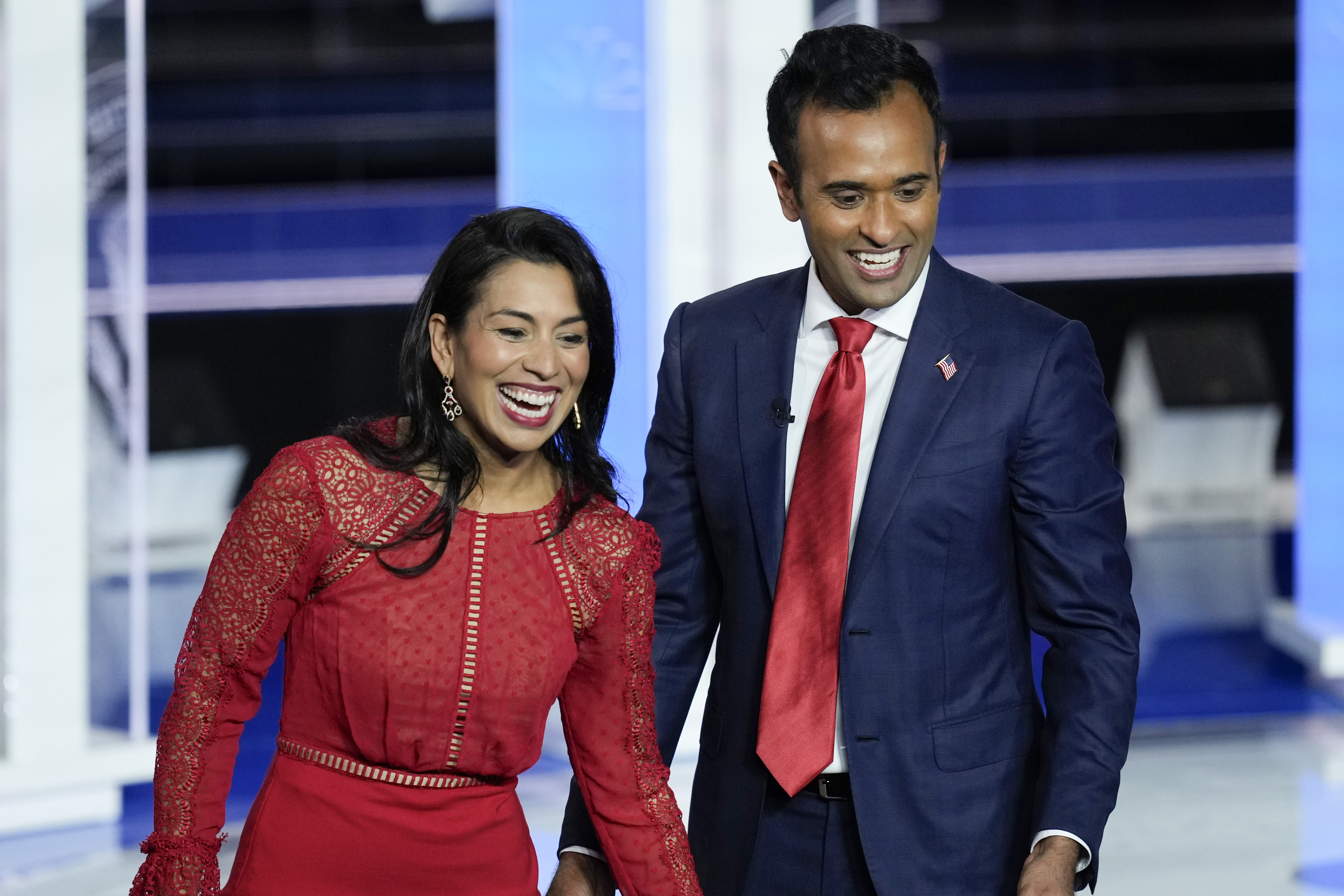 Apoorva Ramaswamy and her husband, Vivek, stand on the debate stage in Miami greeting supporters in the audience.