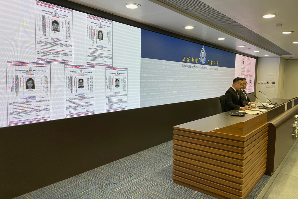 Hong Kong police display arrest warrants for five activists living overseas