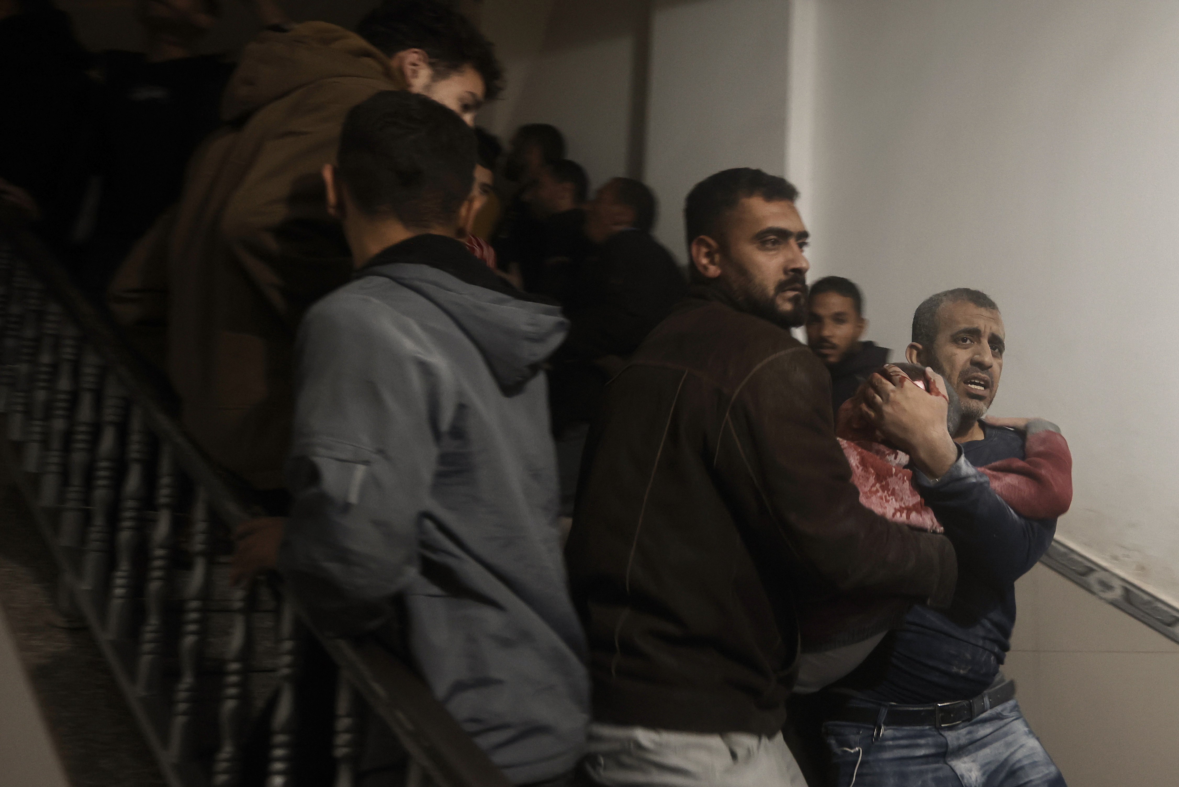 Palestinians evacuate a wounded boy following Israeli strikes on the maternity ward at Nasser Hospital in the town of Khan Younis, southern Gaza Strip.