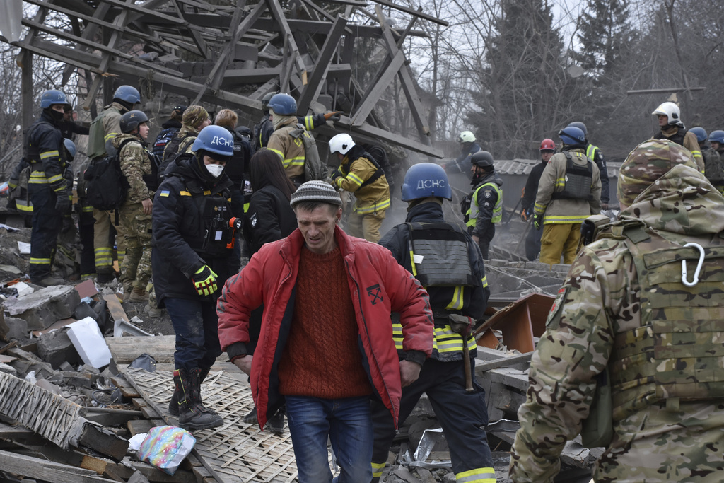 People clear the debris at the site of Russia’s air attack in Zaporizhzhia, Ukraine, on Friday, December 29
