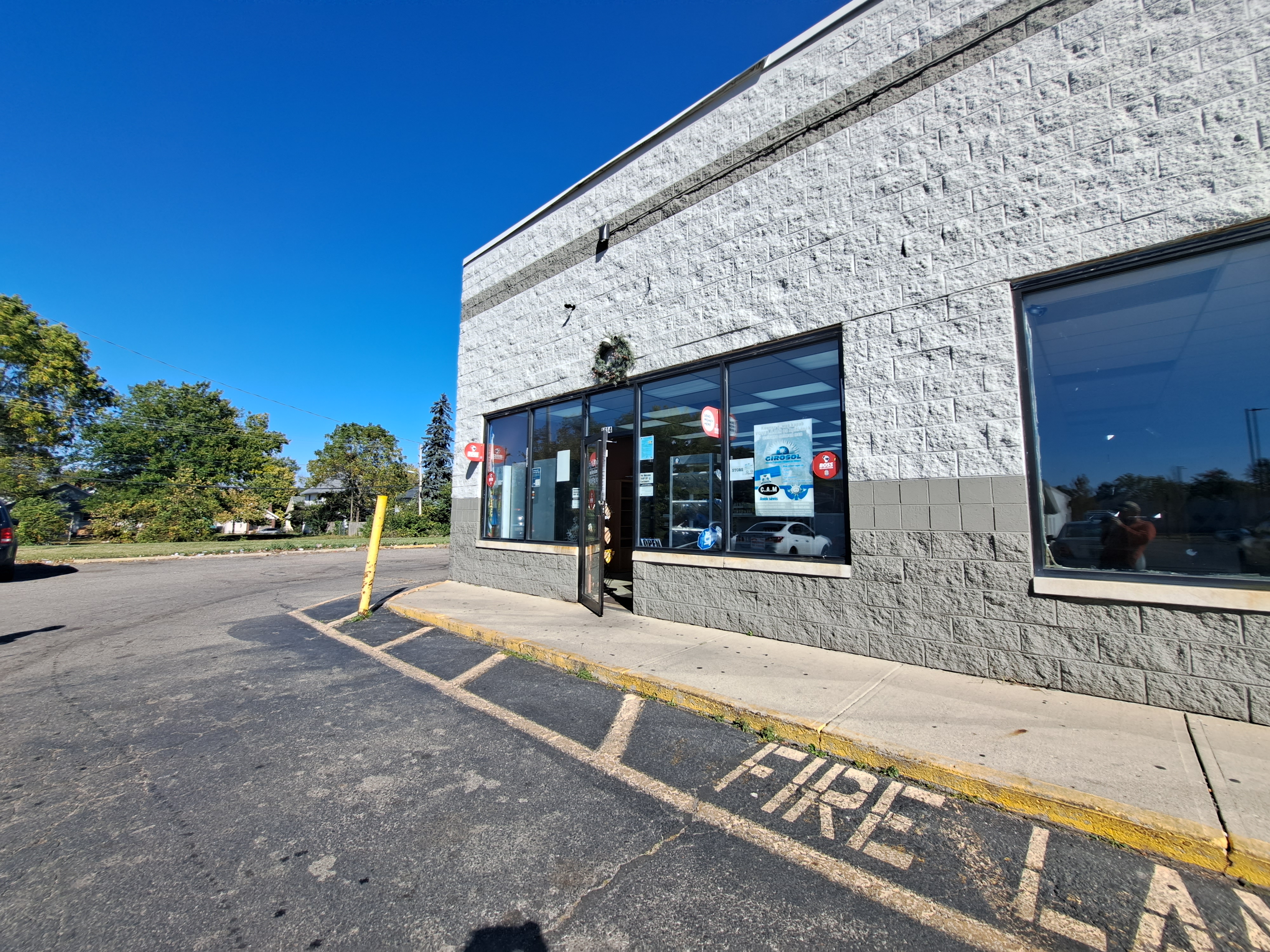 The exterior of Friendly's Bakery, a concrete building with a fire lane outside.
